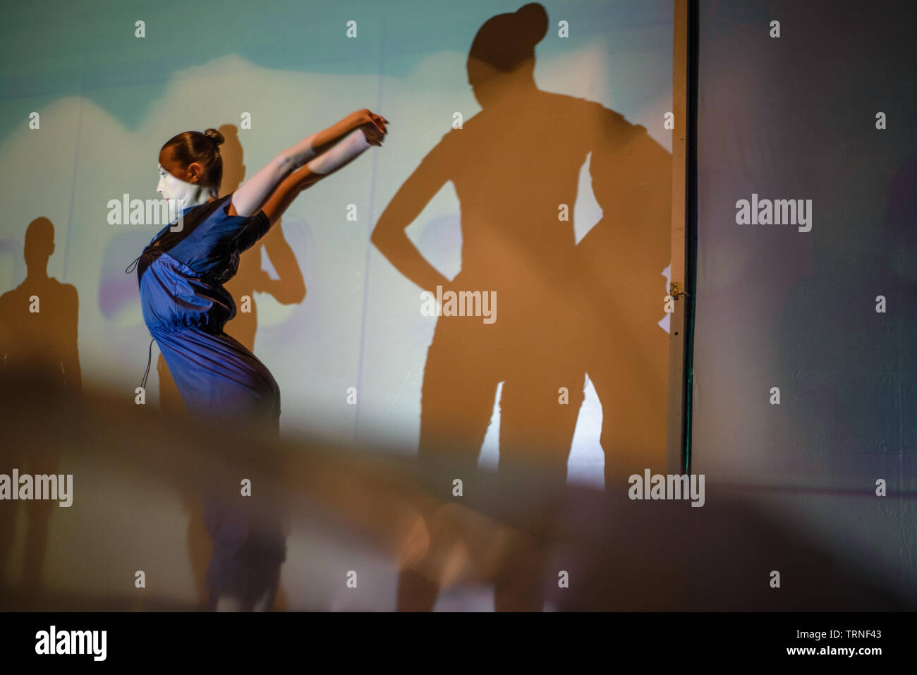 Artists of Teulis Shadow Theater during the performance in Kiev, Ukraine. Artists of the theater create performances using the flexibility and plasticity of their own body. Stock Photo