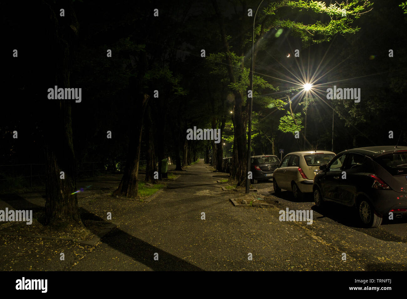 Artificial light versus natural. Little Moon in the background Stock