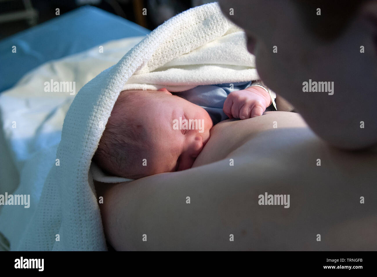 New born baby breastfeeding for the first time Stock Photo