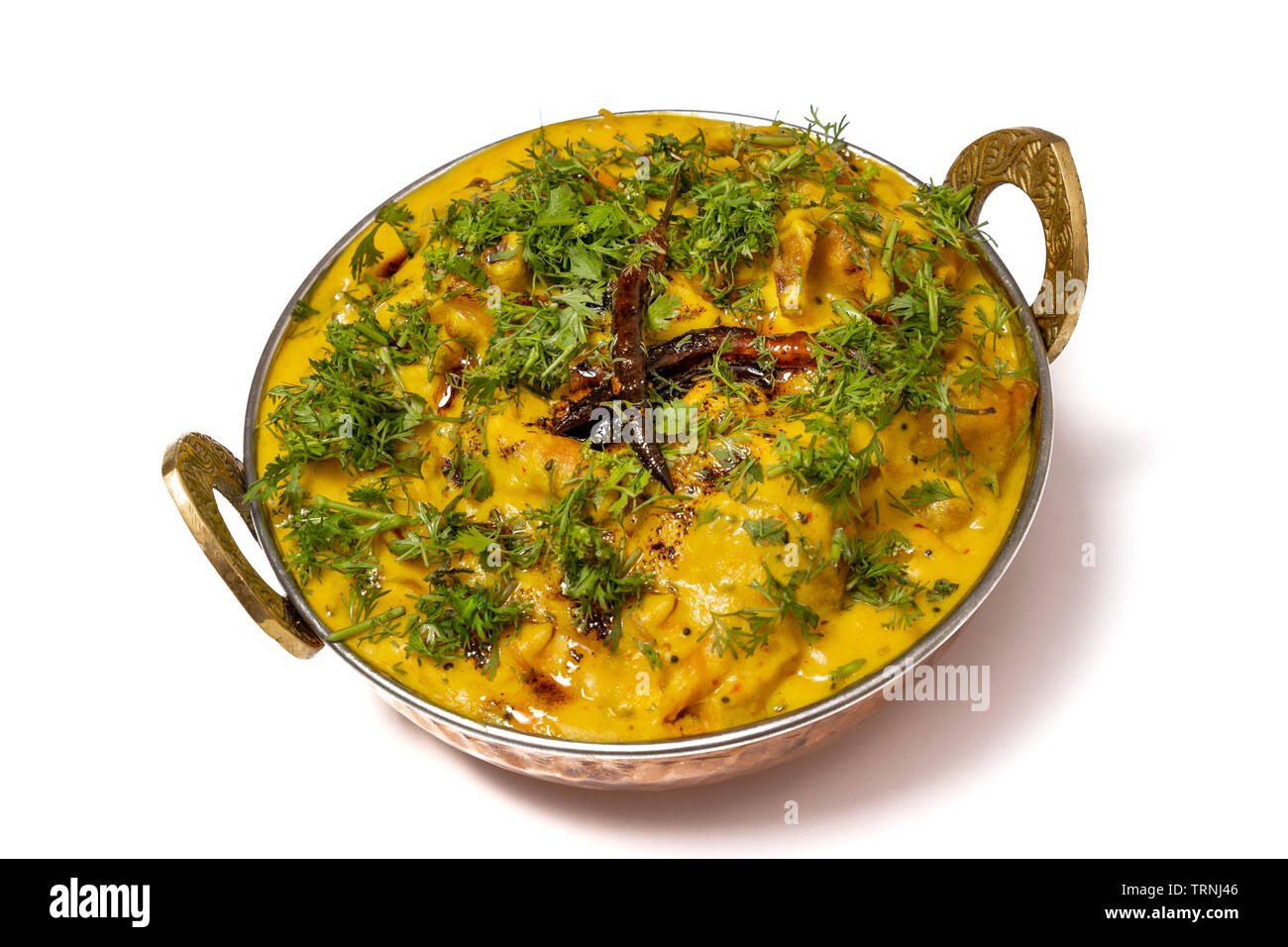 https://c8.alamy.com/comp/TRNJ46/kadhi-pakoda-or-pakora-indian-cuisine-served-in-a-brass-kadai-or-bowl-isolated-on-white-background-TRNJ46.jpg