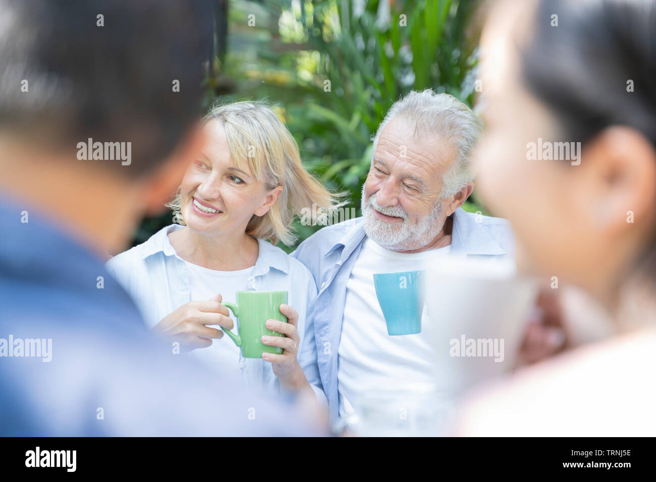 Happy moments. Joyful retirement age nice couple having tea and laughing while enjoying their time together - Image Stock Photo