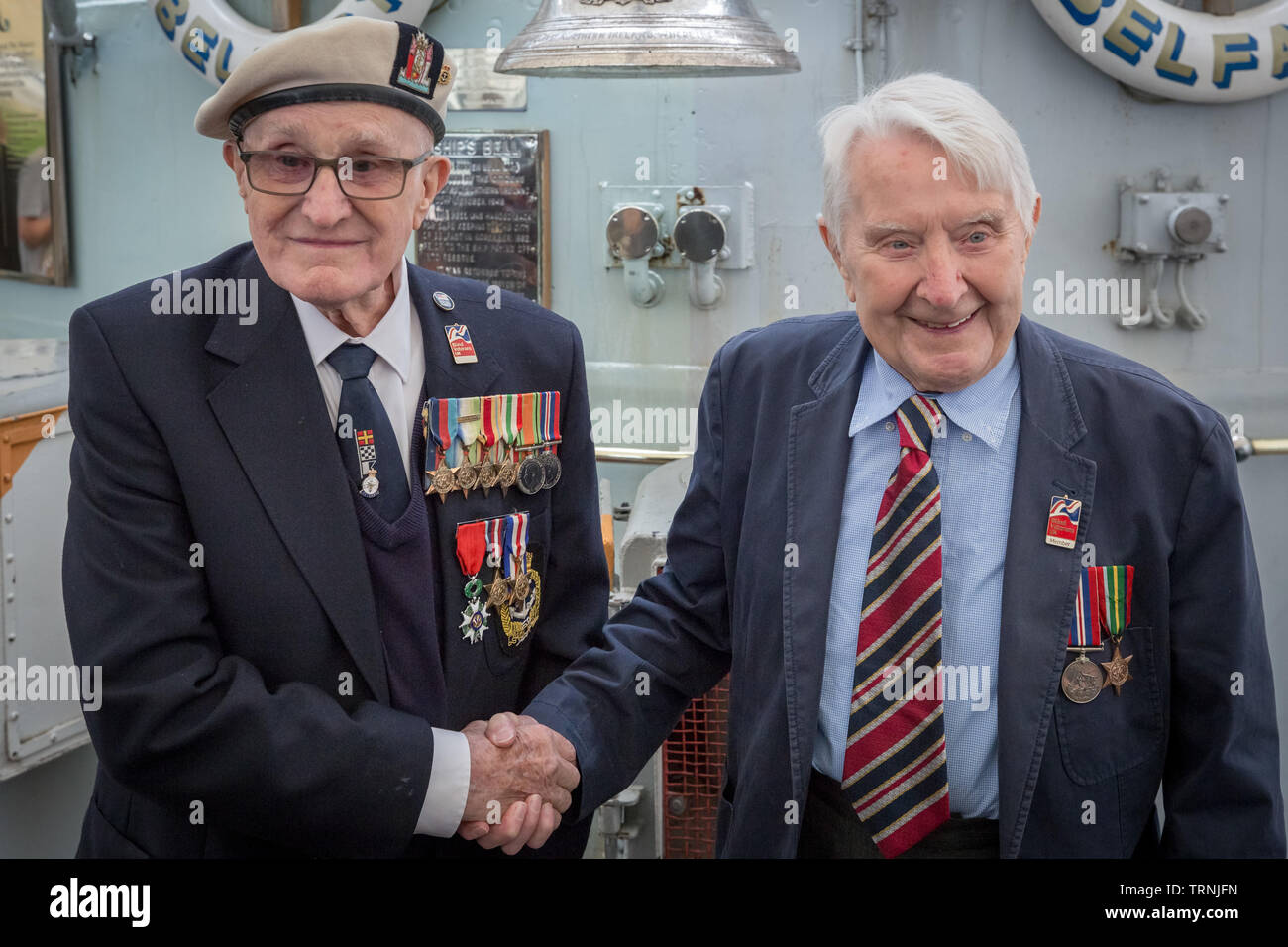 London, UK. 6th June 2019. Imperial War Museum marks 75th anniversary of the D-Day landing on board HMS Belfast. D-Day veterans from Blind Veterans UK board the HMS Belfast, the ship that led the Allied fleet on D-Day. L-R John Connelly and Nev Lees. Credit: Guy Corbishley/Alamy Live News Stock Photo