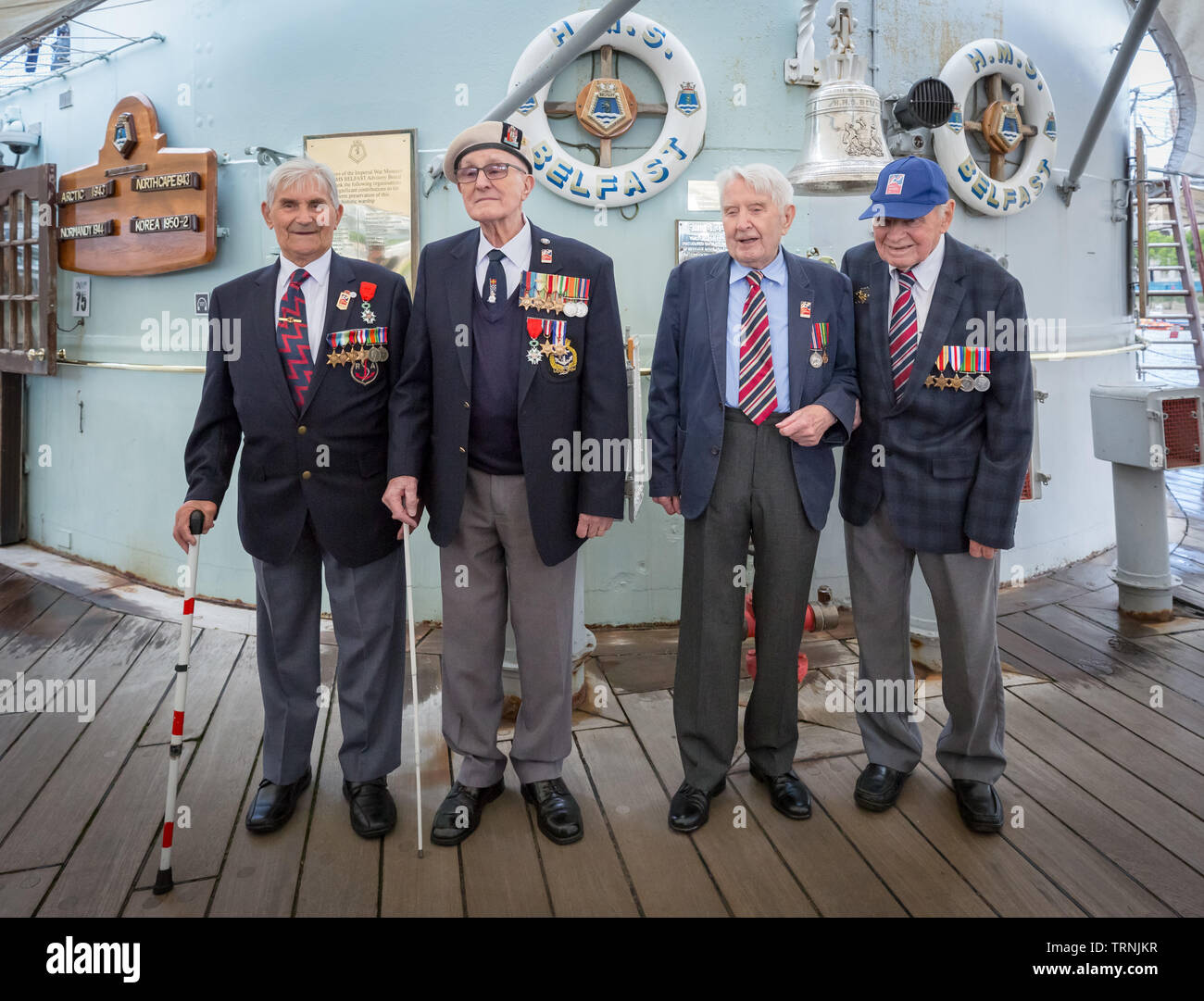 London, UK. 6th June 2019. Imperial War Museum marks 75th anniversary of the D-Day landing on board HMS Belfast. D-Day veterans from Blind Veterans UK board the HMS Belfast, the ship that led the Allied fleet on D-Day. L-R Arthur Barnes, John Connelly, Nev Lees and Bob Jones. Credit: Guy Corbishley/Alamy Live News Stock Photo