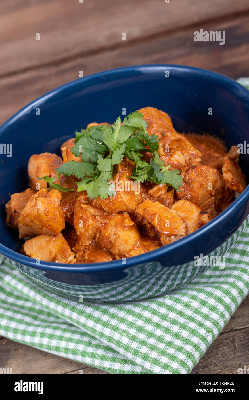 delicious indian butter chicken curry dish with cilantro on top Stock Photo Alamy