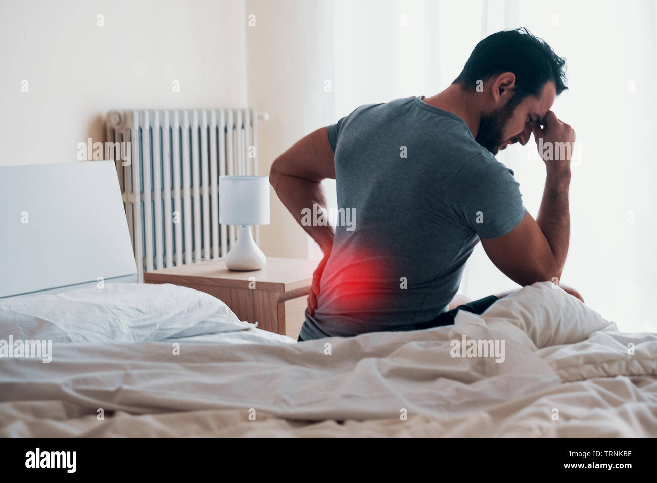 Man feeling backache after sleeping in bed Stock Photo Alamy
