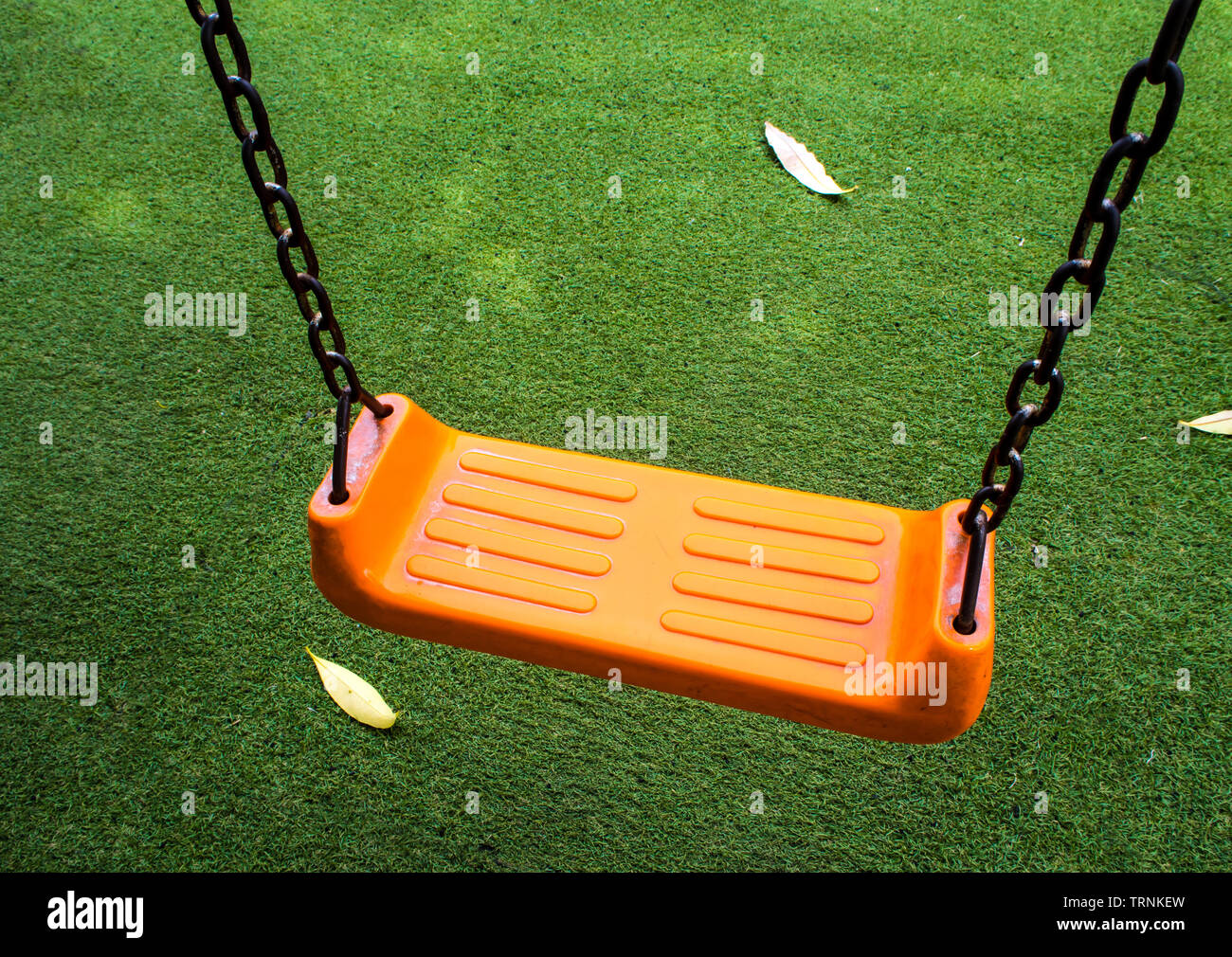 Swing seat on the artificial grass Stock Photo Alamy