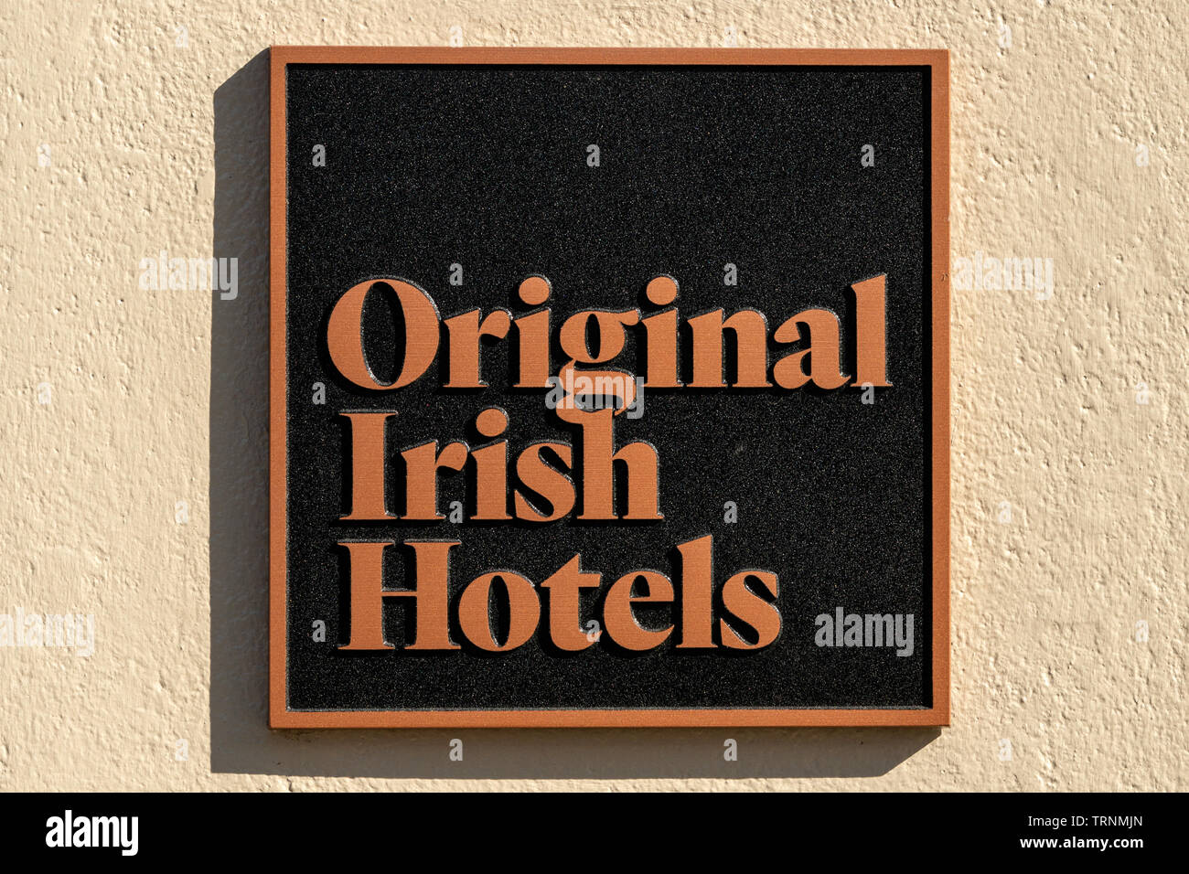 'Original Irish Hotels' metal placard sign on hotel wall - guaranteed best acommodation service within. Stock Photo