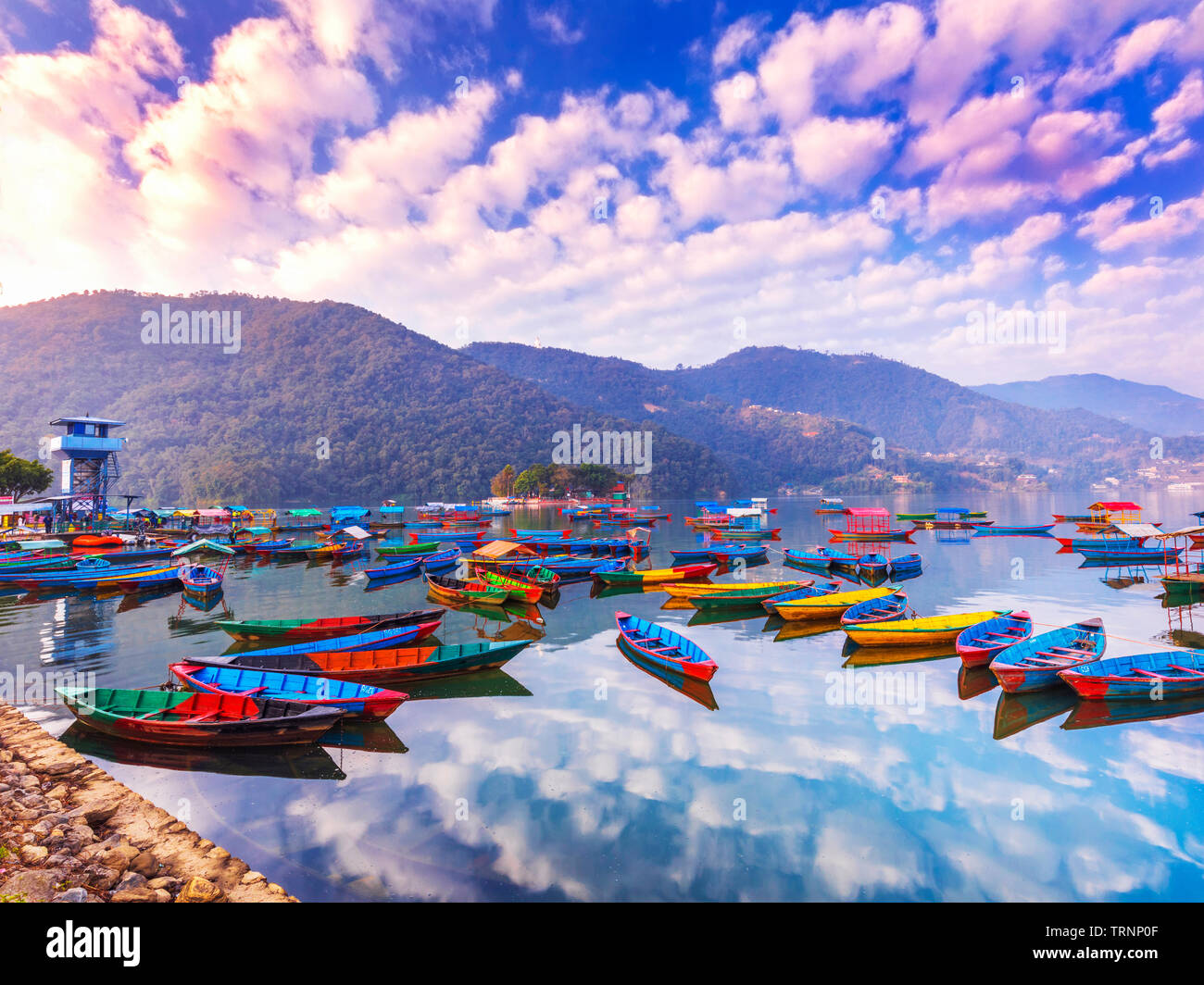 Colorful Nepal Boats Parking in Phewa lake Pokhara.with Sky Reflection in the Lake Pokhara Nepal. Stock Photo