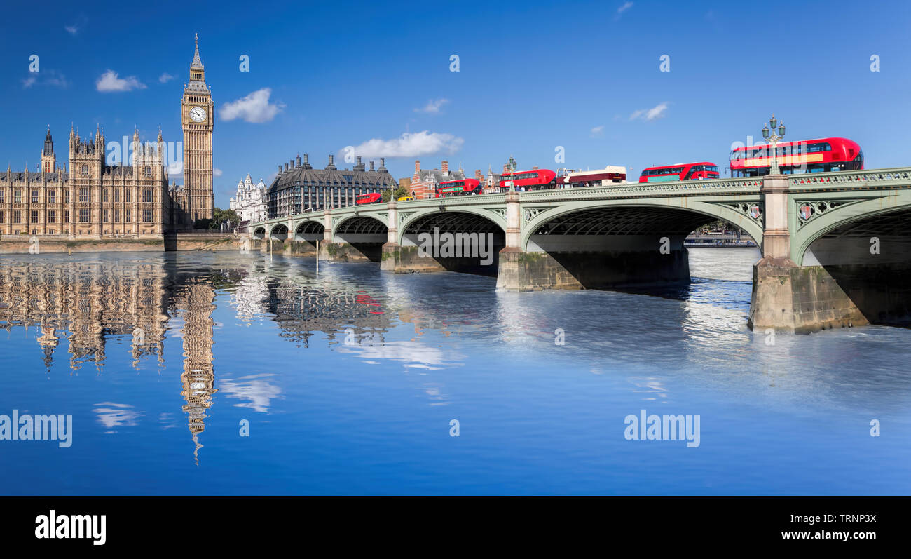 Big Ben and Houses of Parliament with red buses on the bridge in London, England, UK Stock Photo