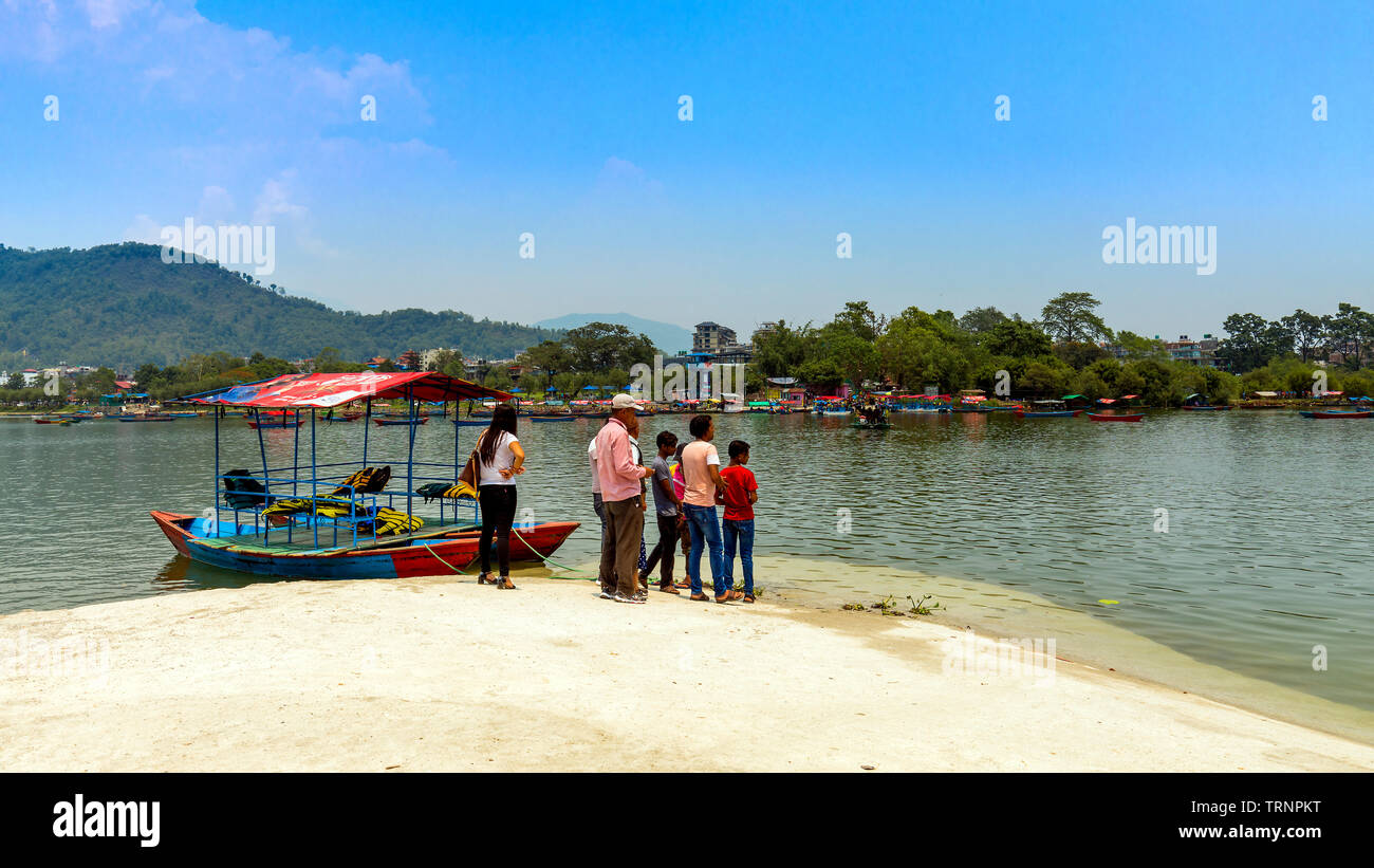 People Waiting For Boats in Tal Barahi Temple Boat Bay view from Tal Barahi Temple Pokhara Nepal. 21 May 2019. Stock Photo