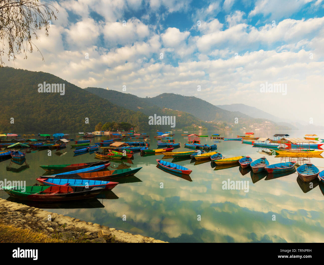 Nepal Boats with different colors,the blue Sky Reflection in the water.Phewa Lake Pokhara Nepal. Stock Photo