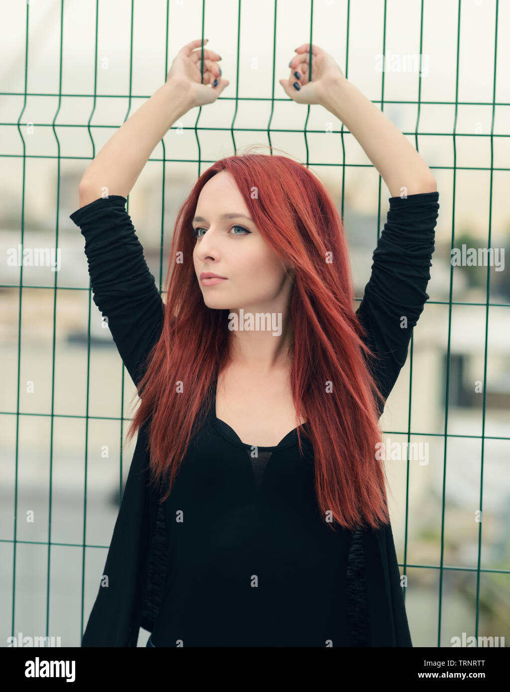 Portrait of attractive red haired young woman with blue eyes. Stock Photo