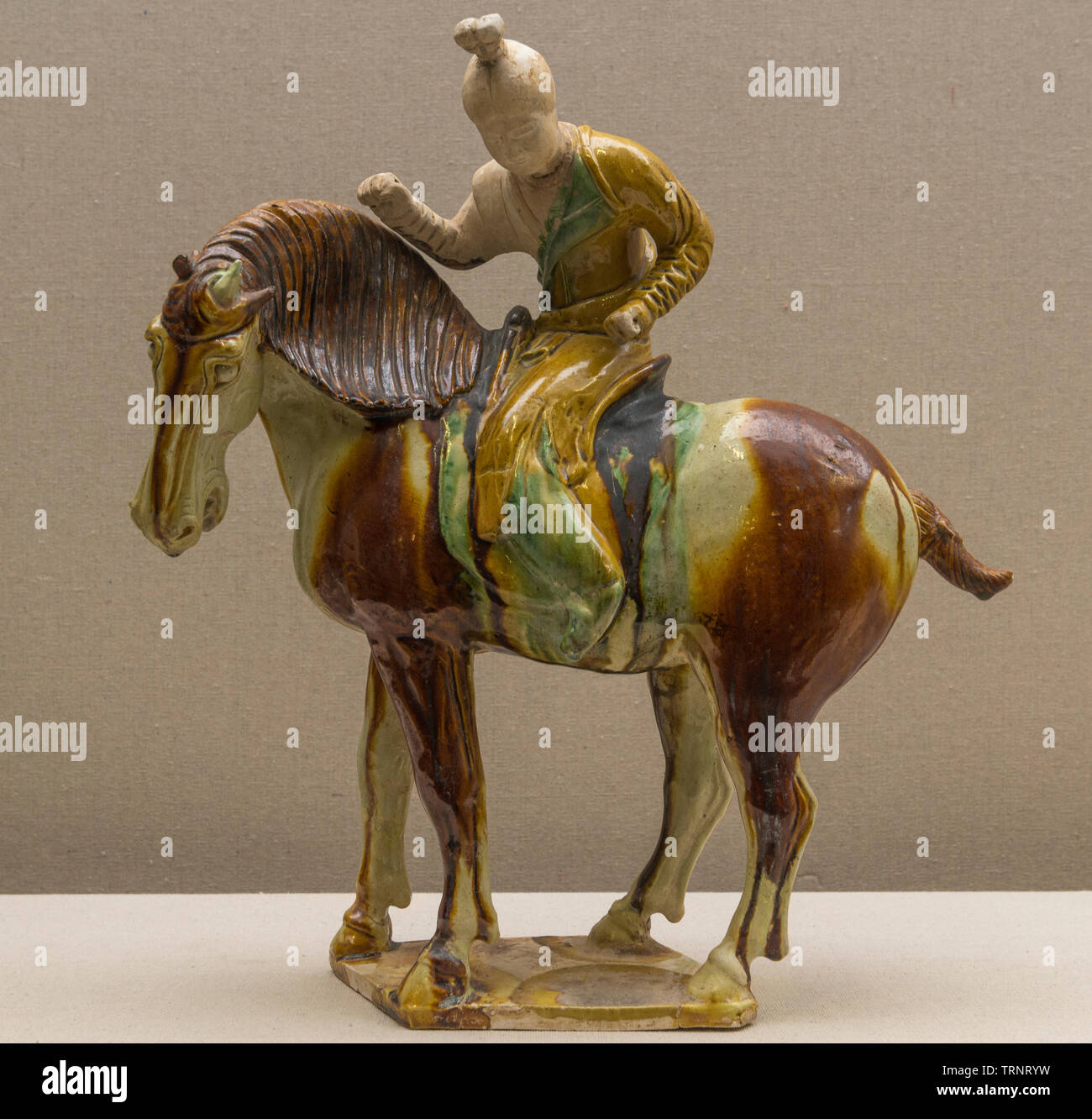 Tri-colored Glazed Pottery Figurine of Polo Player. 618 AD - 907 AD (Tang Dynasty) Luoyang City Culture Relics and Archaeology Research Institute. Stock Photo