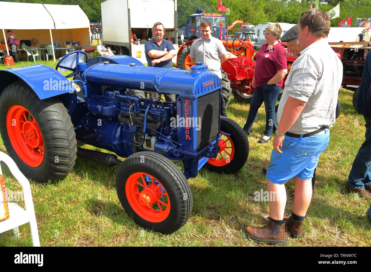 A restored Fordson tractor is admired by visitors at the Woodcote Rally 2019 Stock Photo