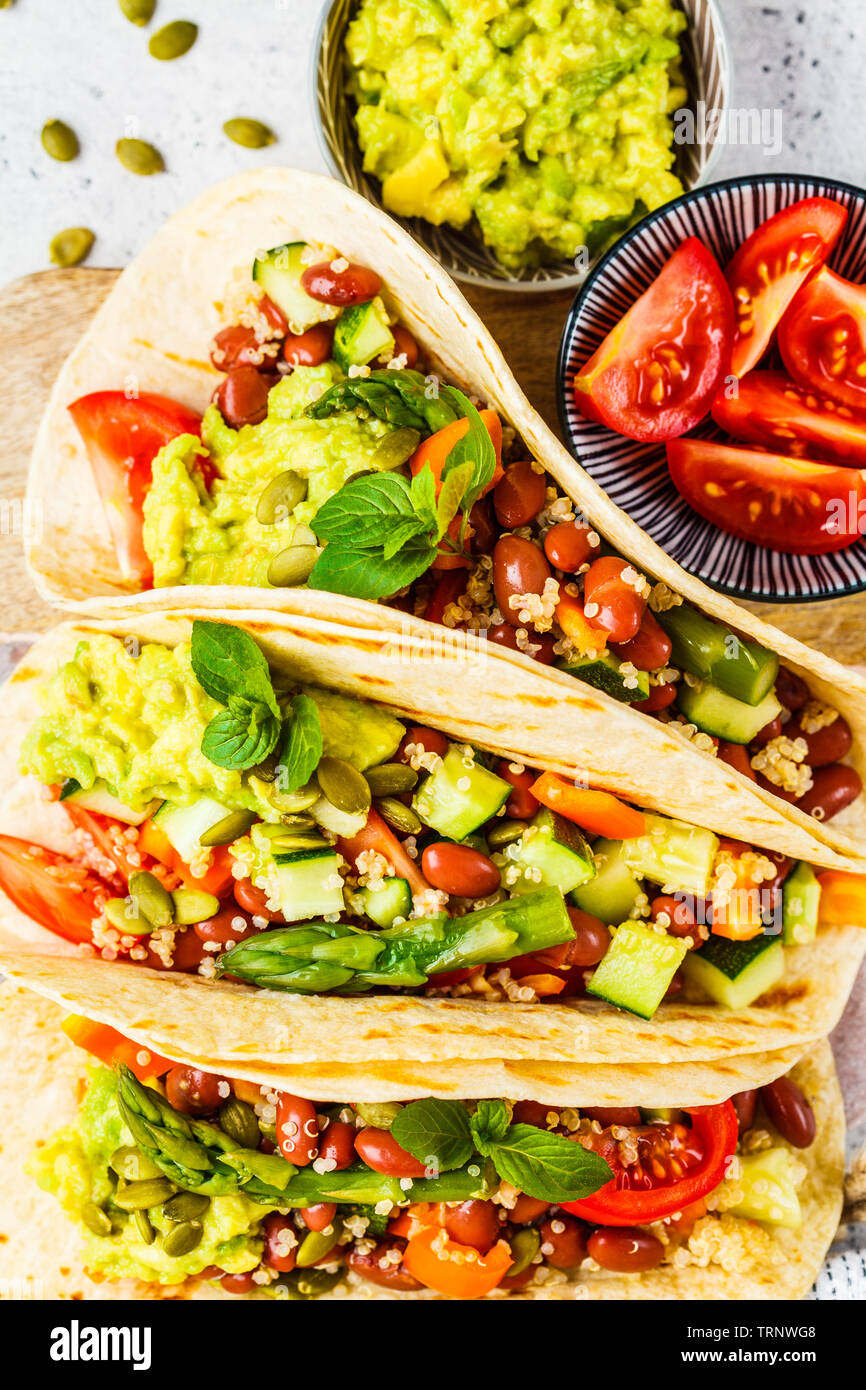 Vegan tortilla wraps with quinoa, asparagus, beans, vegetables and  guacamole Stock Photo - Alamy
