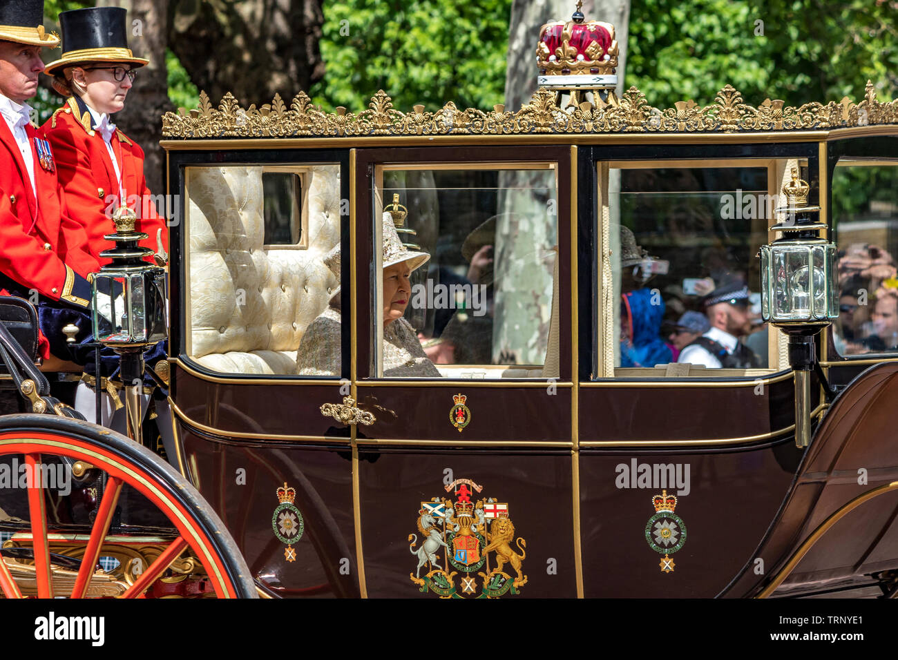 Her Majesty The Queen wearing an Angela Kelly tweed outfit riding in The Scottish State Coach along The Mall at The Trooping The Colour ceremony ,2019 Stock Photo
