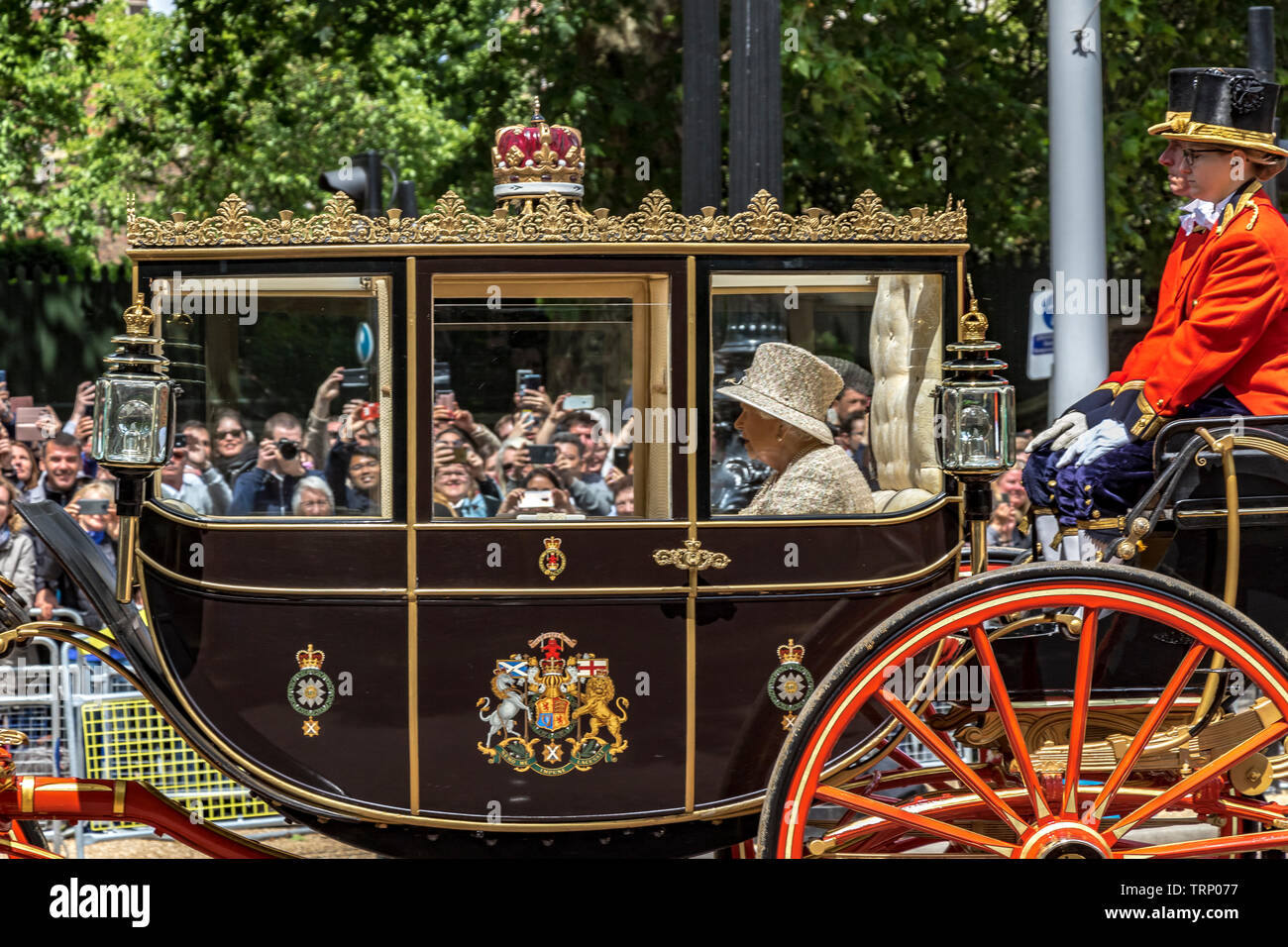 Her Majesty The Queen wearing an Angela Kelly tweed outfit riding in The Scottish State Coach along The Mall at  Trooping The Colour, London, UK ,2019 Stock Photo