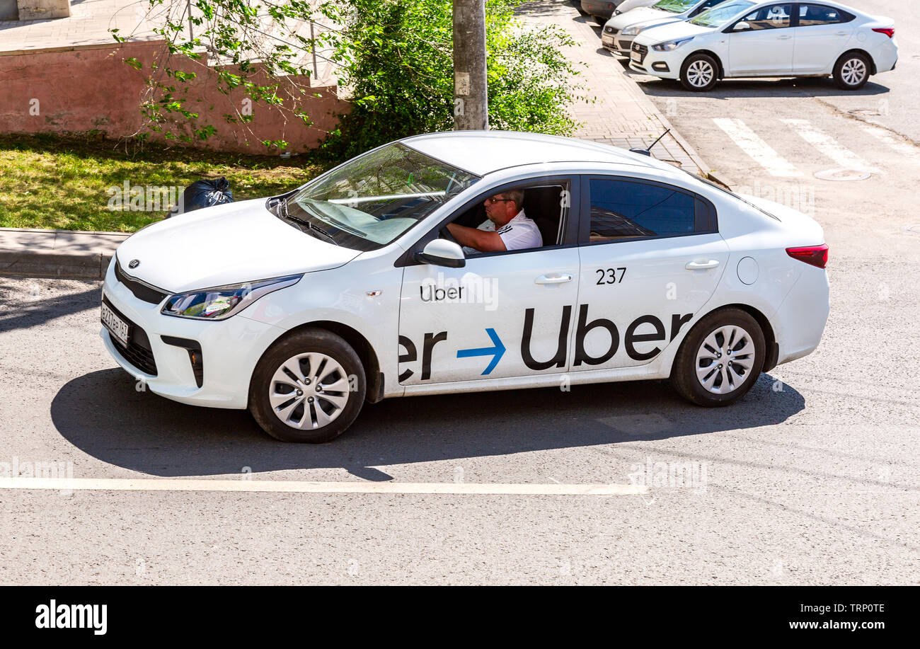 Samara, Russia - June 8, 2019: Uber taxi goes down the street in 