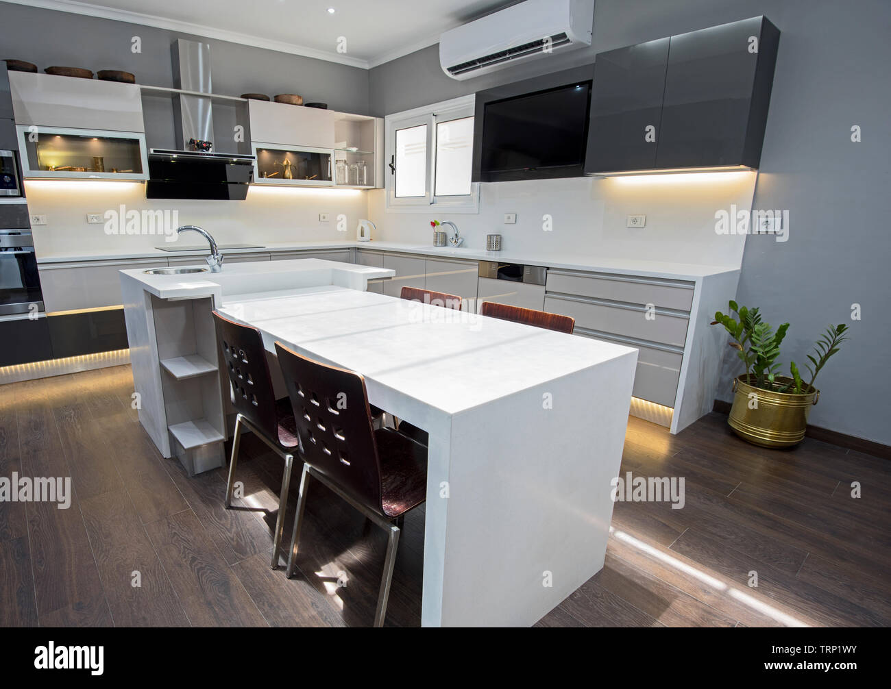 Interior design decor showing modern kitchen with cupboards in luxury apartment showroom Stock Photo