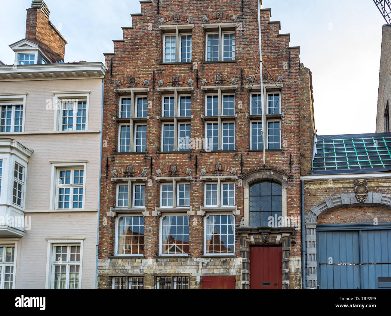 Exterior of medieval house facing one of the canals. Cityscape of Bruges streets shot from the boat. Stock Photo