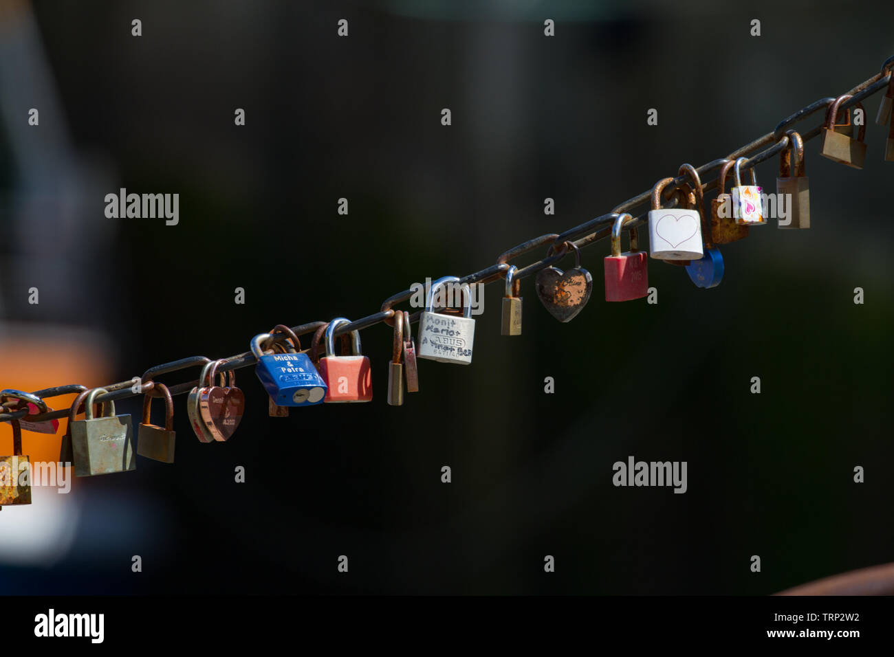 Line of padlocks, love locks, attached to chain by harbourside. Lower