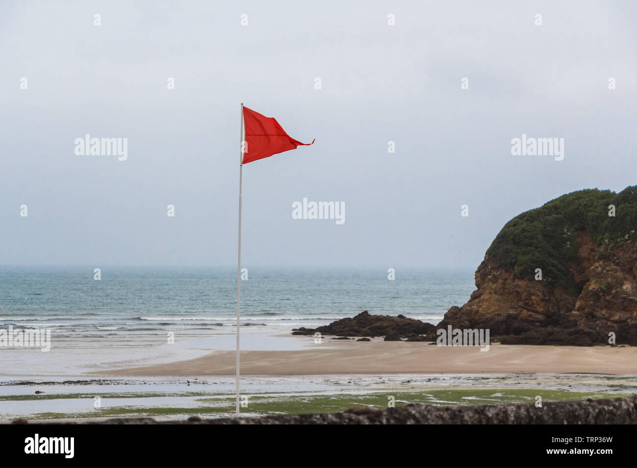 Red flag to prohibit bathing in Ris beach in Douarnenez Stock Photo