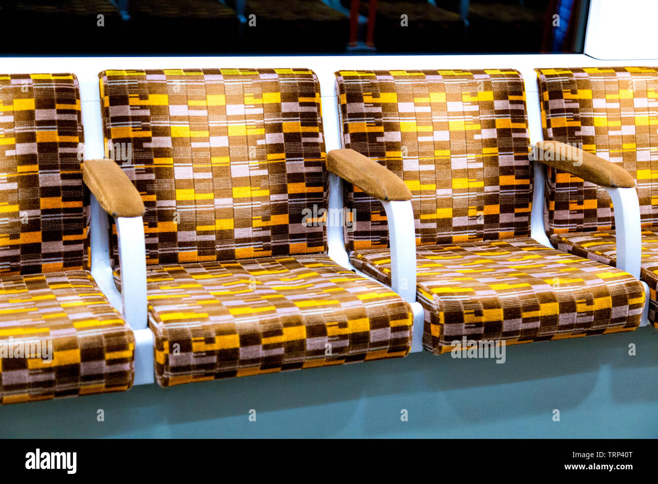 Brown and yellow 1970s style London Underground seats in an Overground train in 2019 Stock Photo