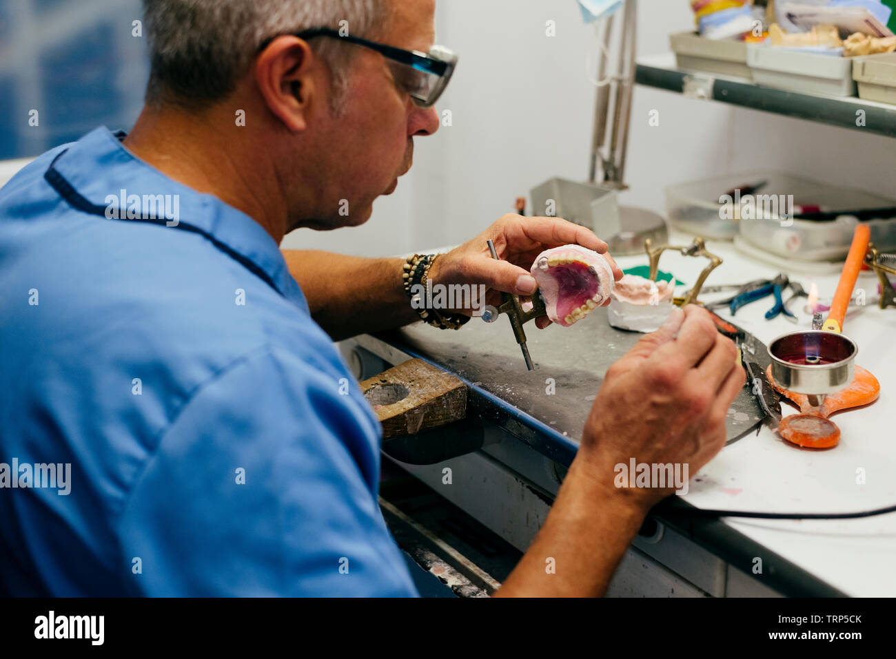 Caucasian man working on a dental prosthesis Stock Photo