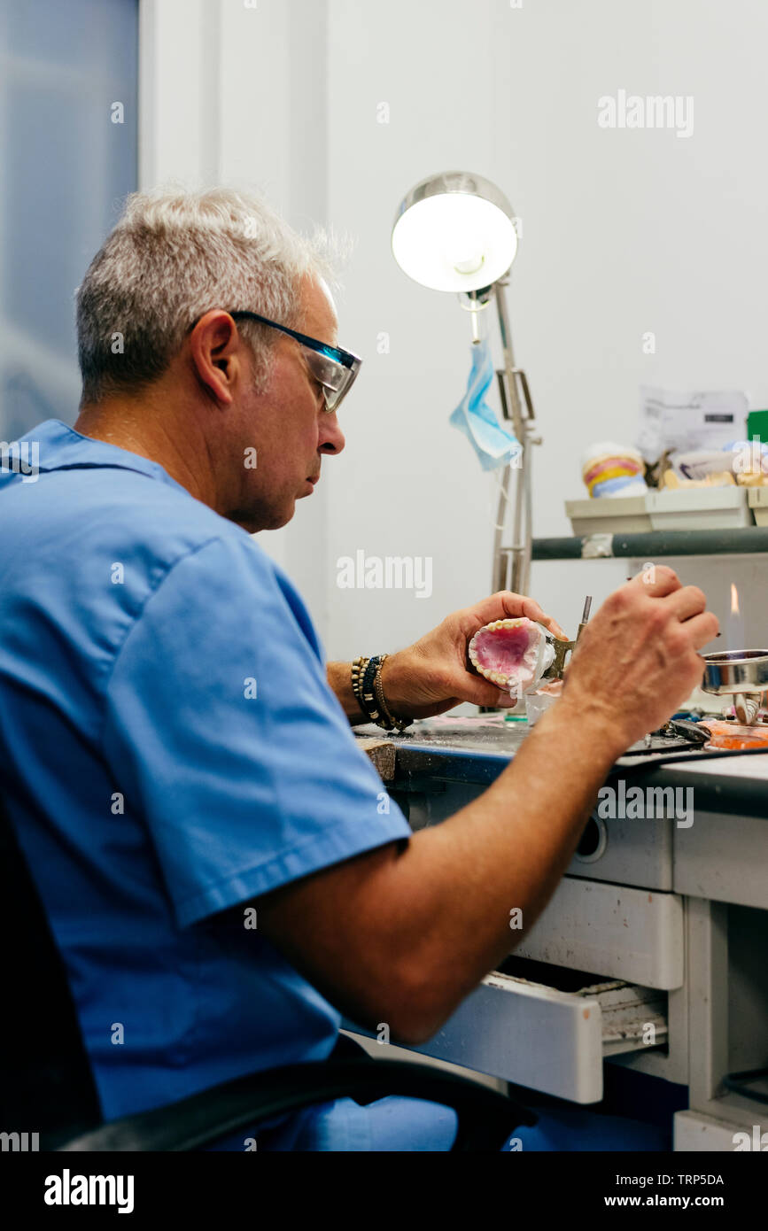 Caucasian man working on a dental prosthesis Stock Photo
