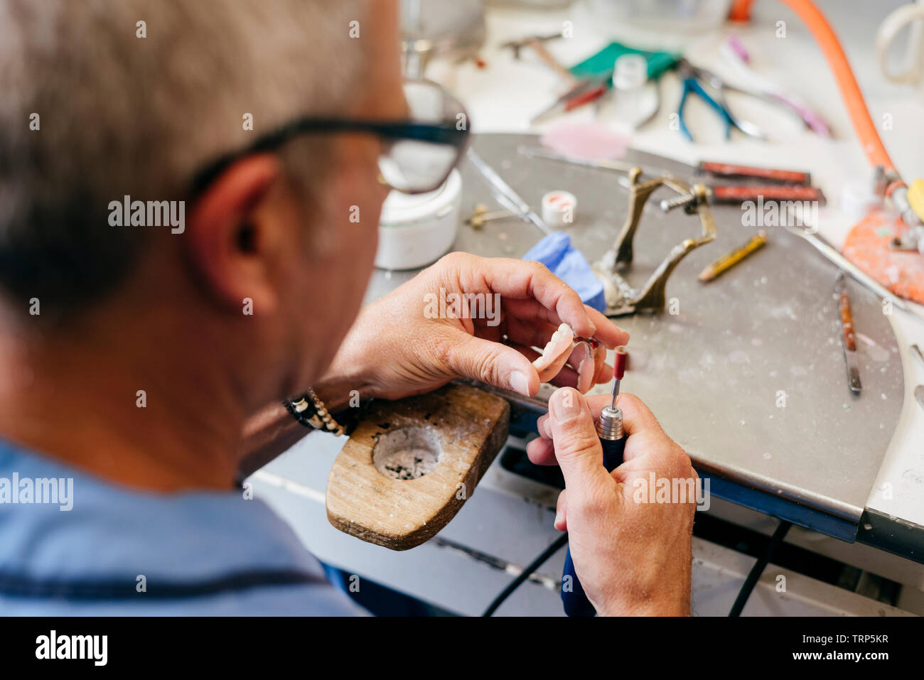 Caucasian man working on a dental prosthesis Stock Photo