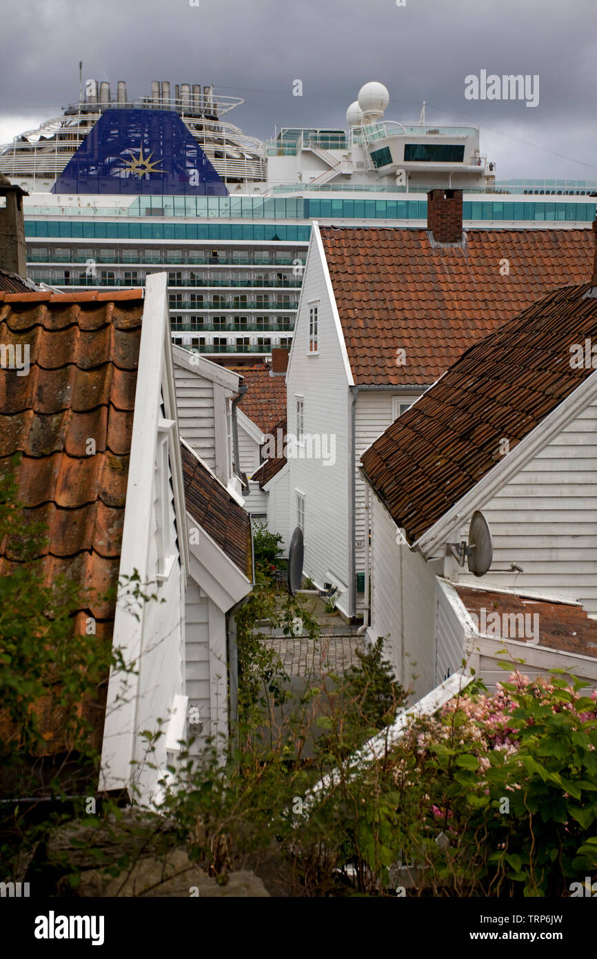 Old white cottages in Gamie Stavanger with cruise ship in background, Norway Stock Photo