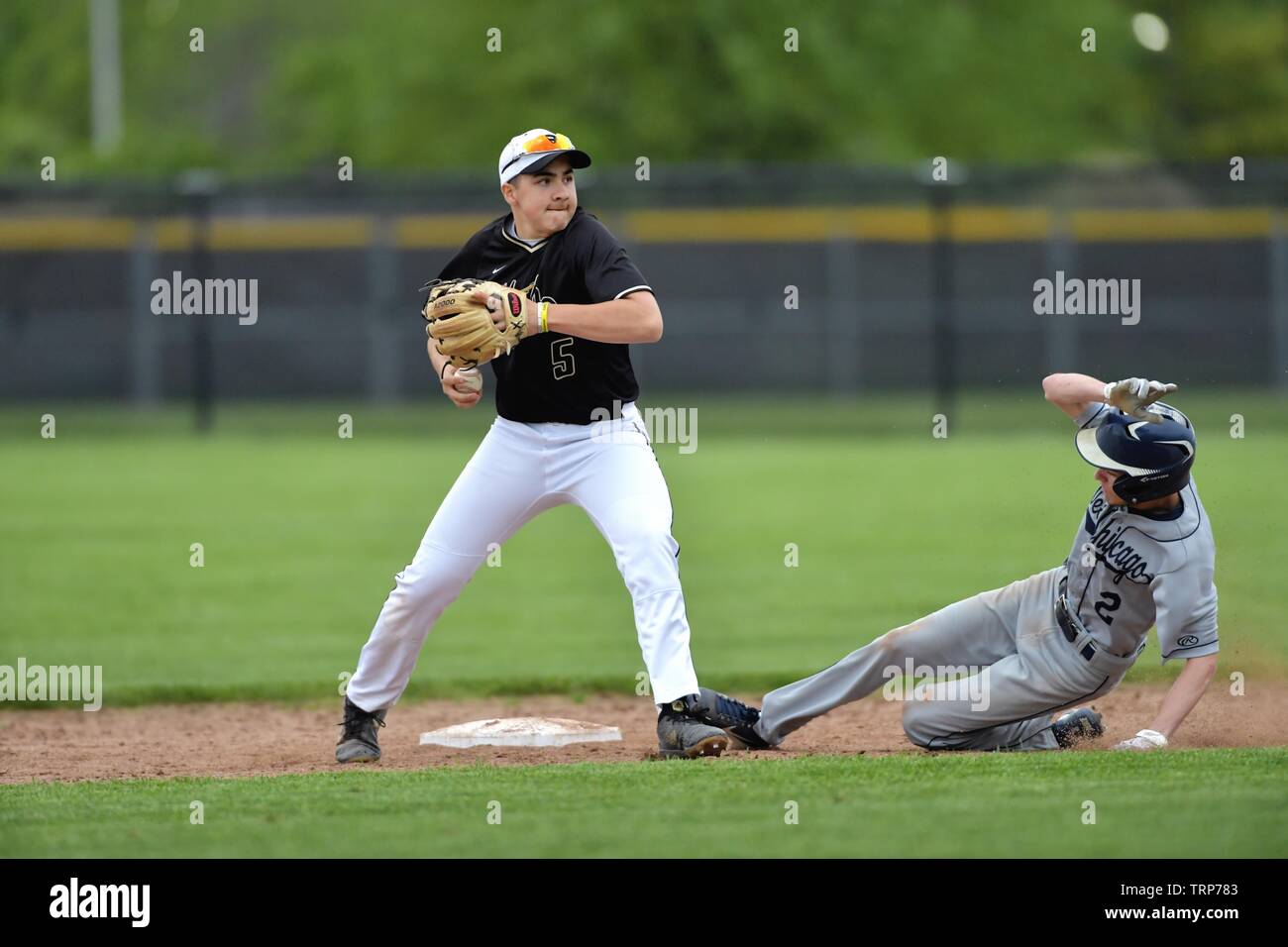 After forcing out an opposing sliding runner at second, the second baseman looked to first base for a possible double play. USA. Stock Photo