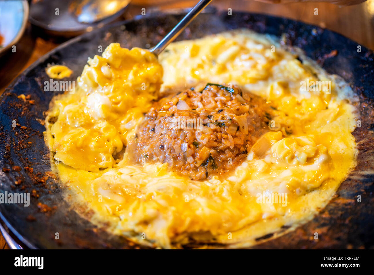 Delicious volcanic shaped fried rice with egg and spicy sauce, pork and squid, famous south korean food in jeju island restaurant, close up Stock Photo
