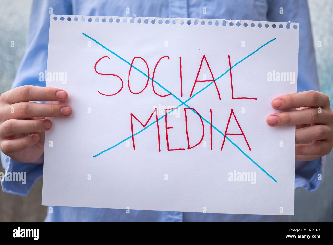Close up Of Sign Held In Front Of Person With The Words Social Media close-up-of-sign-held-in-front-of-person-with-the-words-social-media
