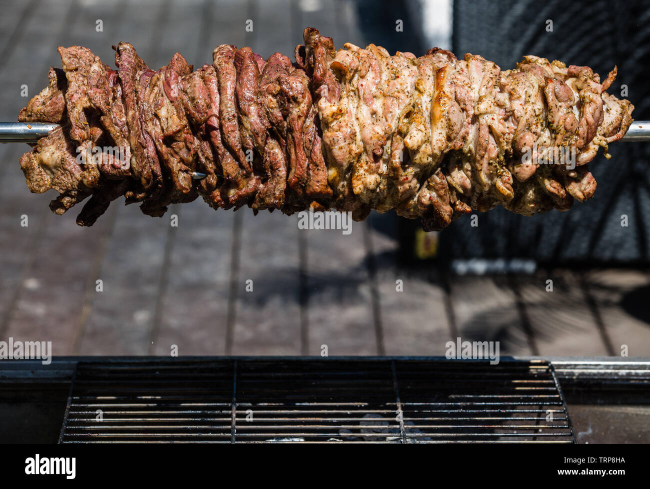 Meat on a spit at an Australian backyard party Stock Photo
