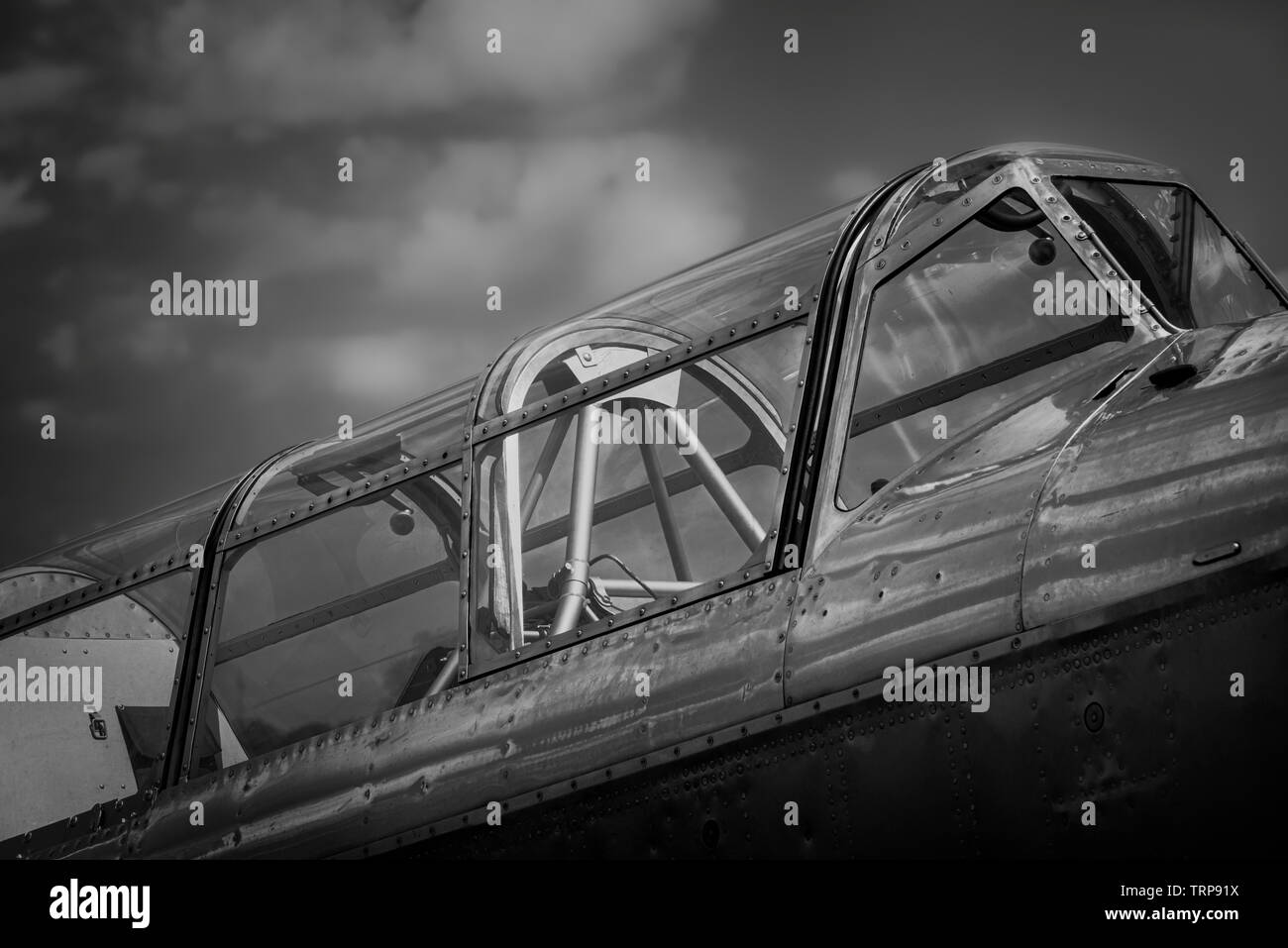 Classic airplane cockpit side view, in black and white settings. Old german military plane with riveted steel Stock Photo