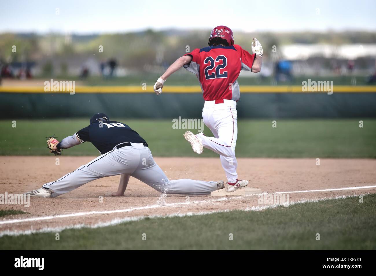 First baseman stretching to take a throw to just in time to retire the batter at first base. USA. Stock Photo