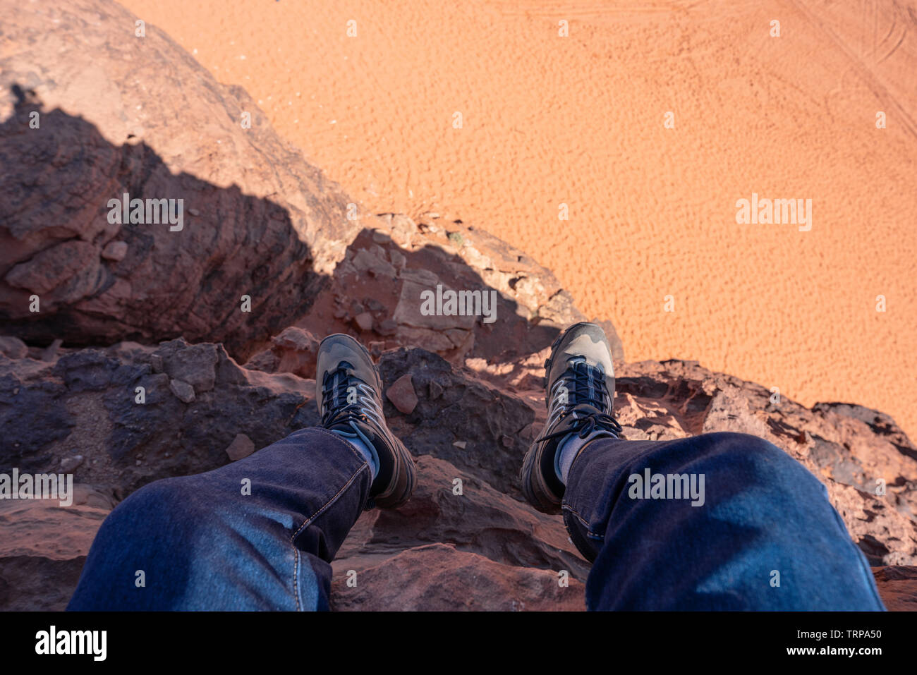 Travelling, hiking and adventurous in desert Middle-East. Traveler enjoying high angle view of desert landscape in Jordan Stock Photo