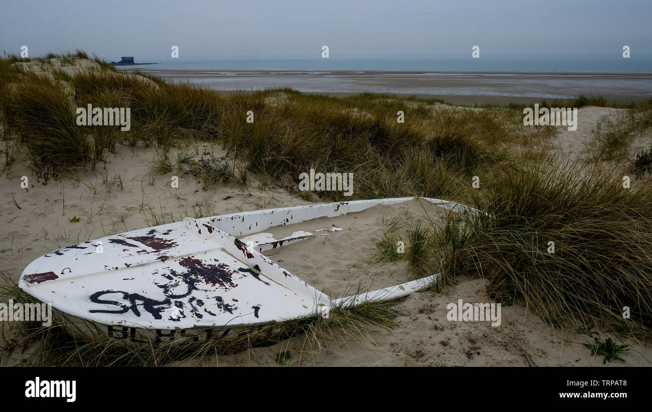 Stranded boat layong in the Sand dunes, Boulogne-sur-Mer, Hauts de France, France Stock Photo