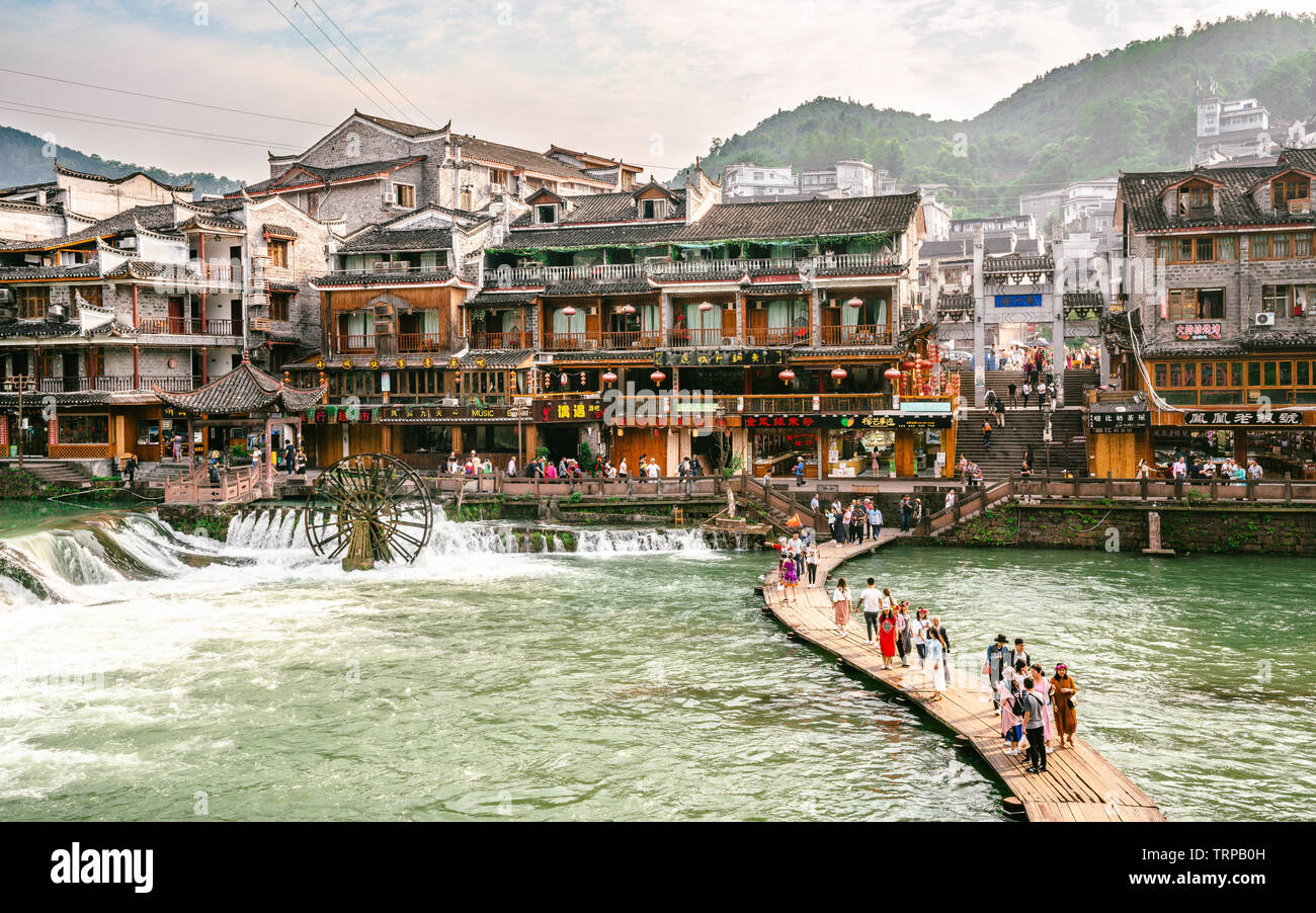 2 June 2019, Fenghuang China : Wooden makeshift bridge and Fenghuang panorama with lots of chinese tourists in phoenix ancient town in Hunan China Stock Photo