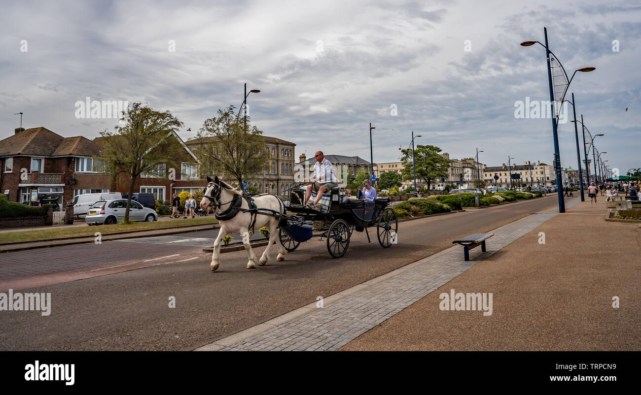 Tourists enjoying a horse and carriage ride along the Golden Mile in