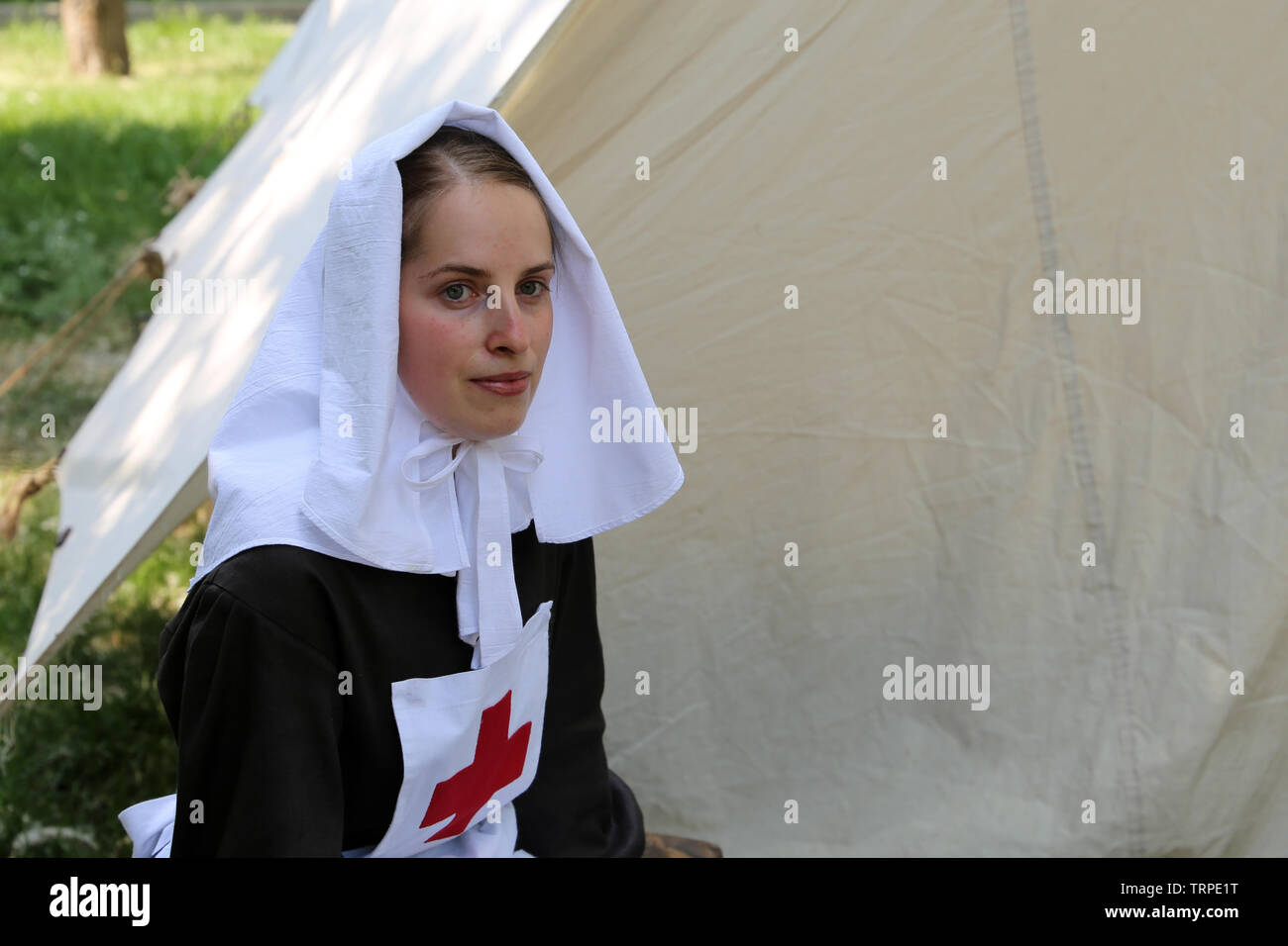 Army nurse of the Russian Empire of 19th century during the Moscow historical festival Times and Epochs. Reconstruction of the military field hospital Stock Photo