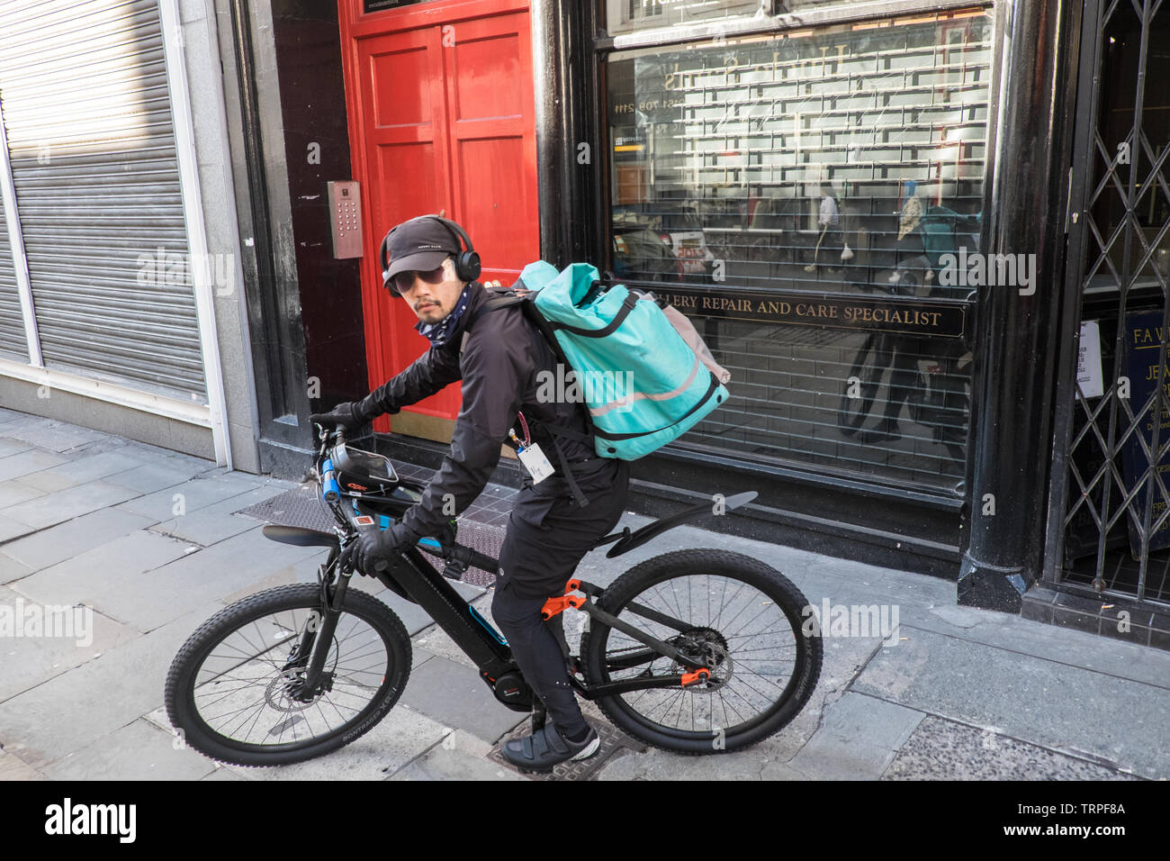 Deliveroo,bicycle,bike,food,courier,on,Bold Street,with,many,food,outlets,Liverpool,Merseyside,Northern,city,England,UK,GB,Great Britain,Europe, Stock Photo