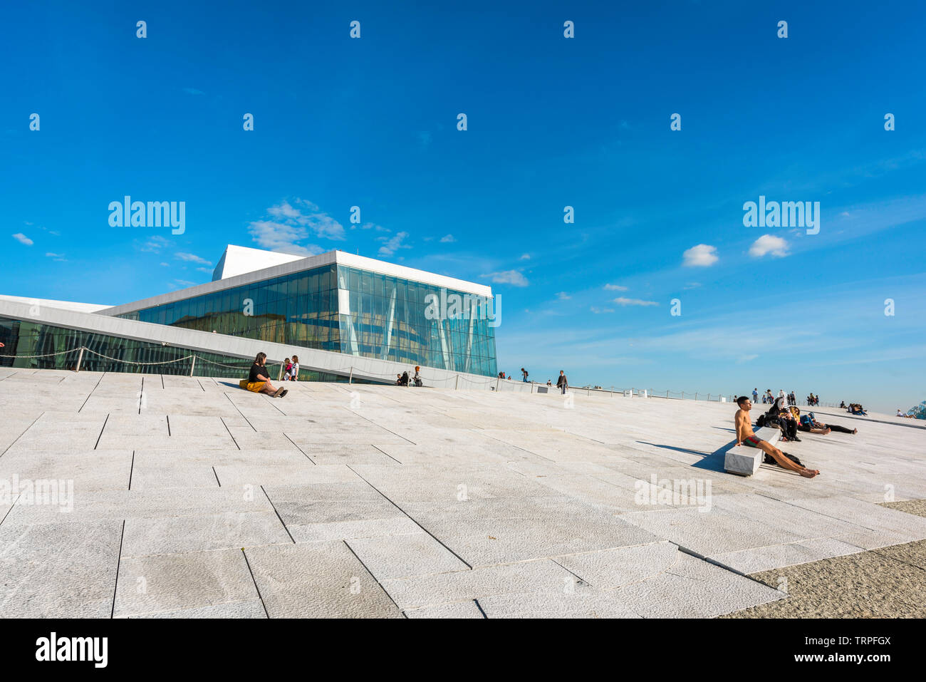 Opera House Oslo, view in summer of people sunbathing along the waterfront concourse of the Oslo Opera House, Norway. Stock Photo