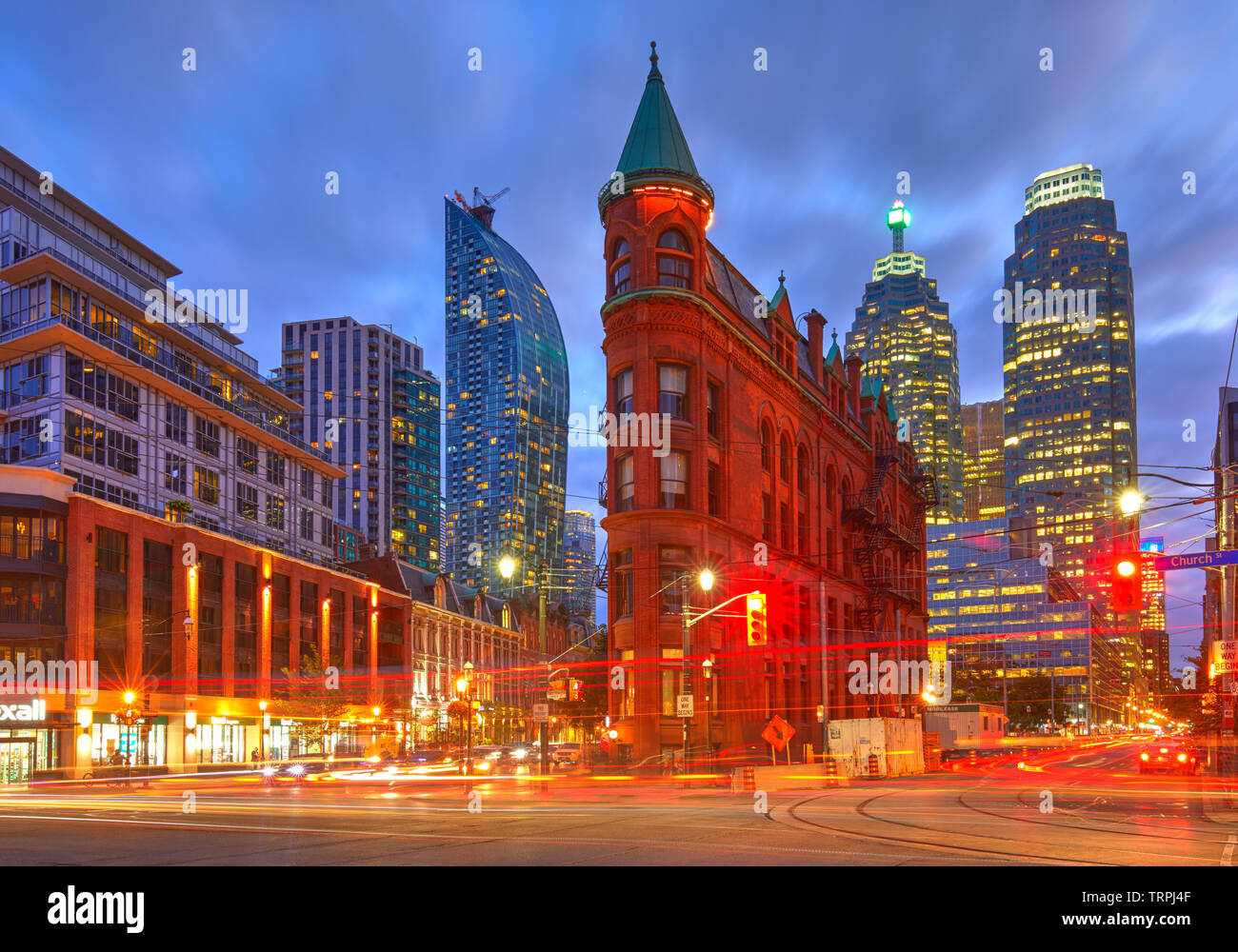 Gooderham Building, also known as the Flatiron Building, during the blue hour with light trails, Toronto, Canada Stock Photo