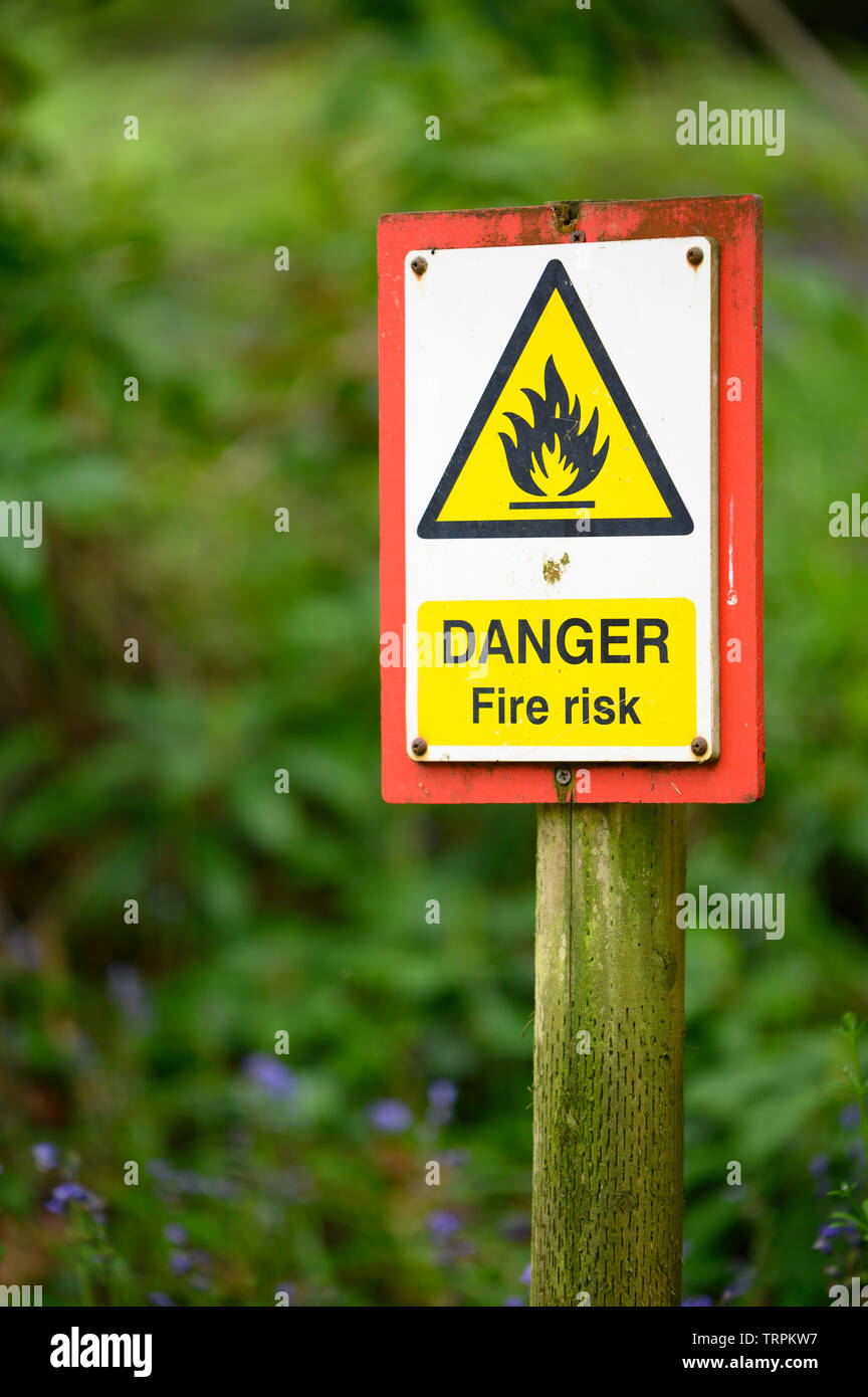 Danger Fire Risk sign on a post in the forest Stock Photo