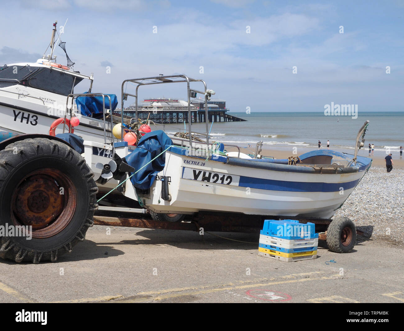 Crab fishing boats hauled ashore on the beach at Cromer, a holiday