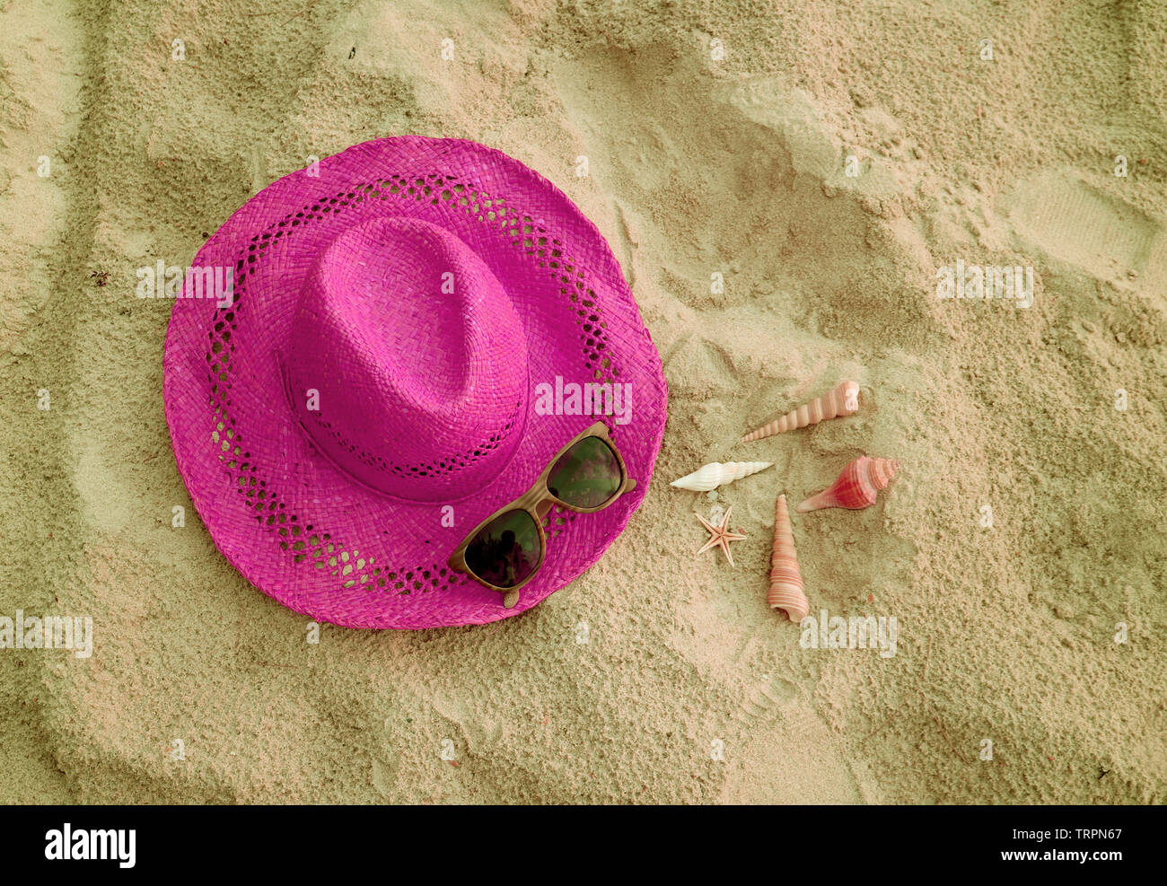 Shocking pink straw hat with sunglasses and many little seashells on ...