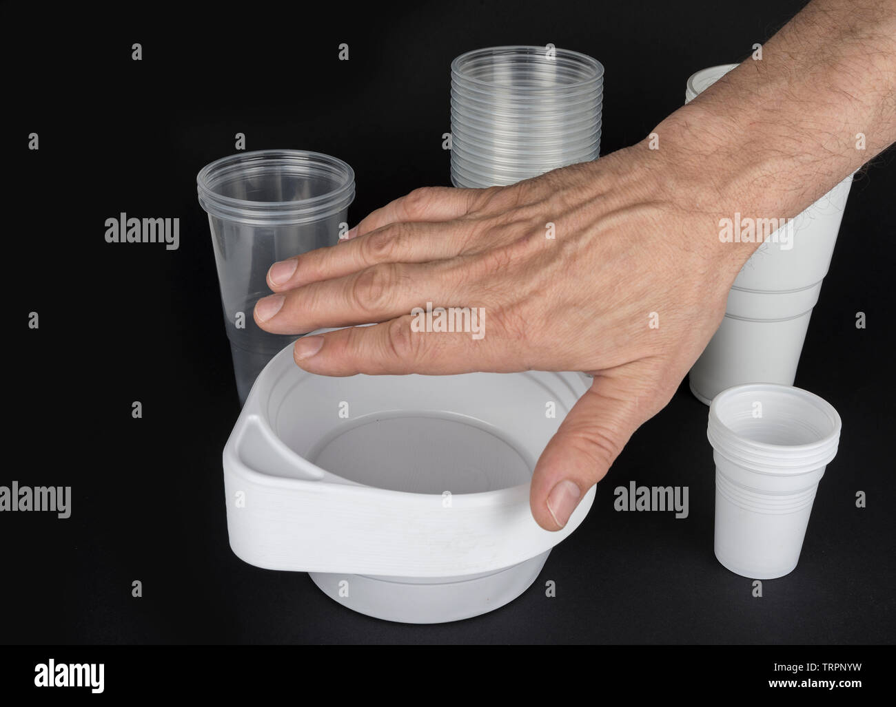 Disposable plastic ware on a black background Stock Photo Alamy