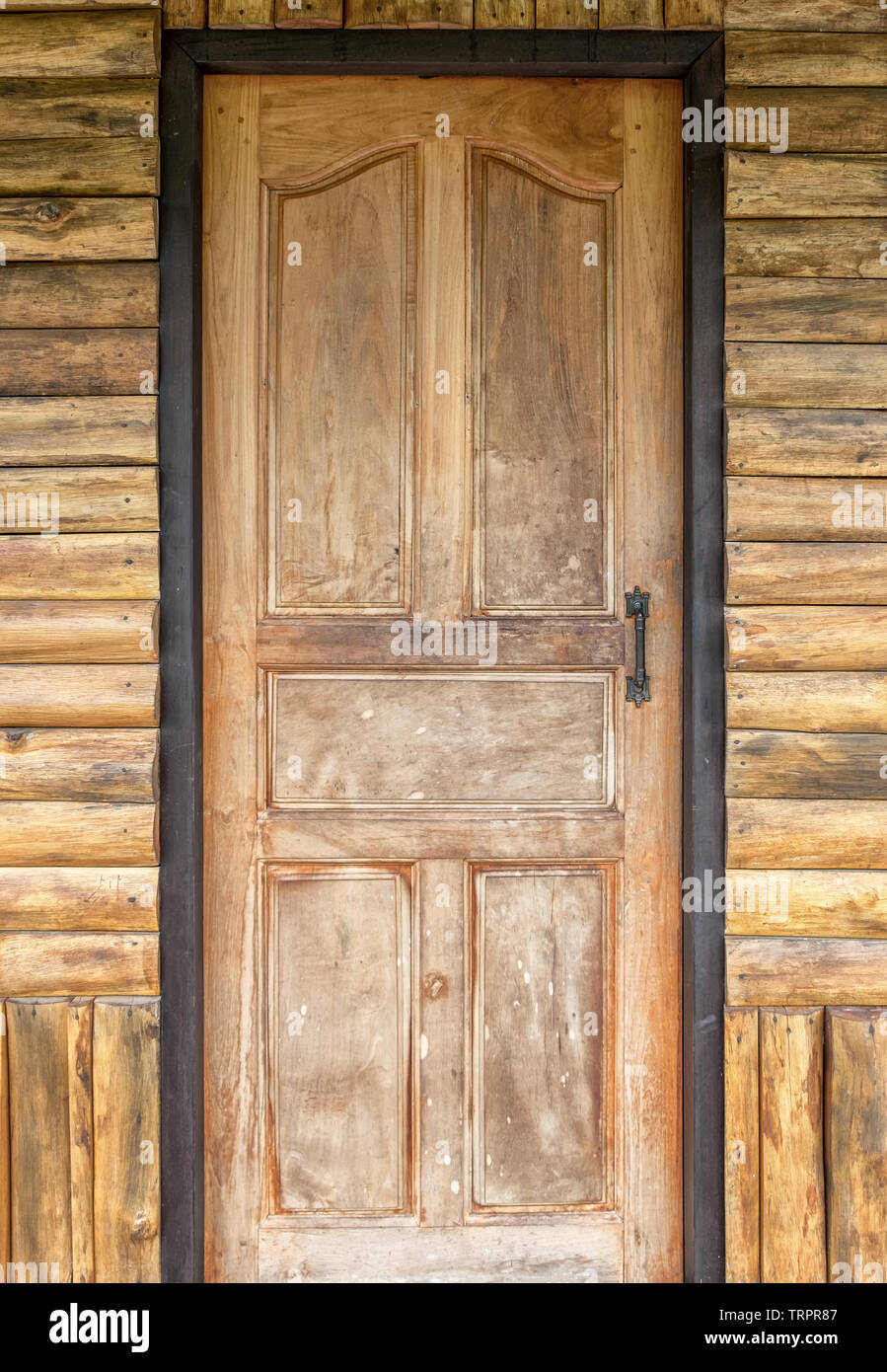 Wood door on the teak house wall Stock Photo